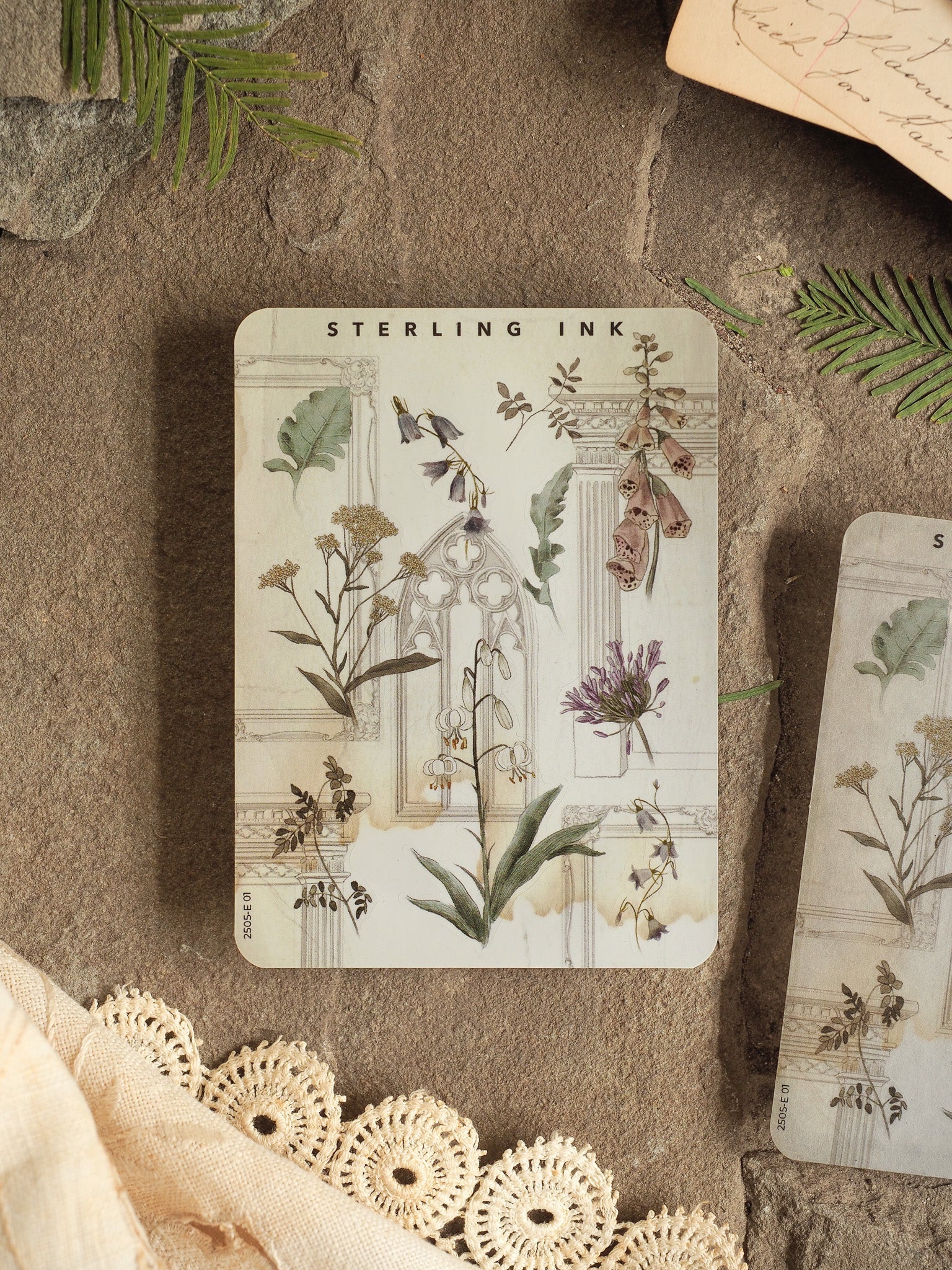 Elegant botanical sticker featuring antique illustrations of delicate mixed flowers and foliage, labeled "Sterling Ink."