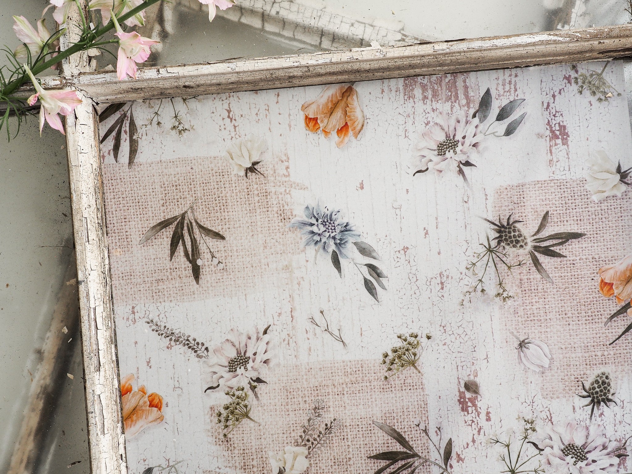 Muted botanical sticker sheet patterned with assorted spring florals, delicate leaves, and soft, faded blooms in creams and sage tones.