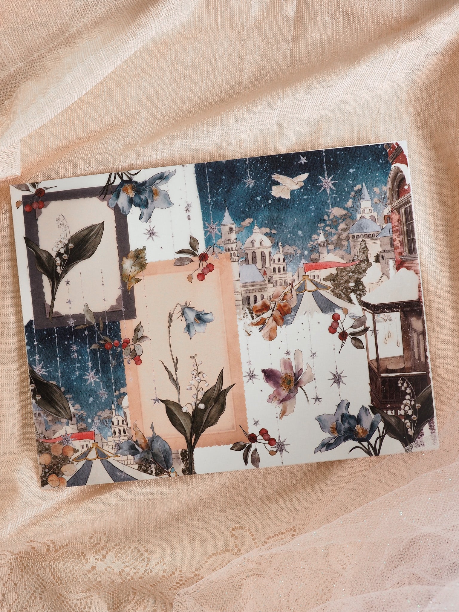 Layered winter sticker set featuring a snowy European town, dark blue irises, snowflakes, and delicate seasonal floral accents for journaling.