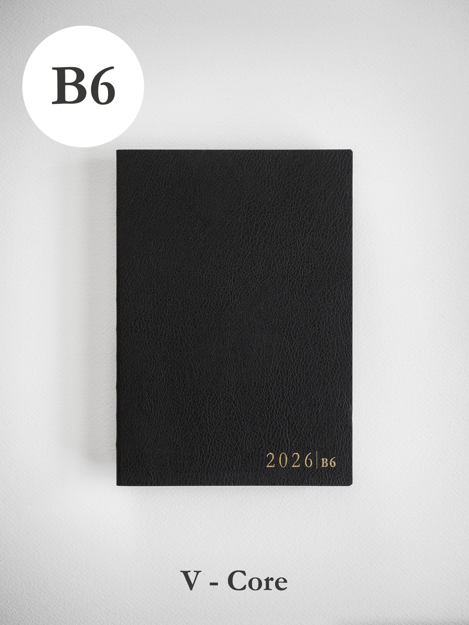 Minimalist, matte black vertical journal or book cover, branded with the clean, white text "2026 B6."