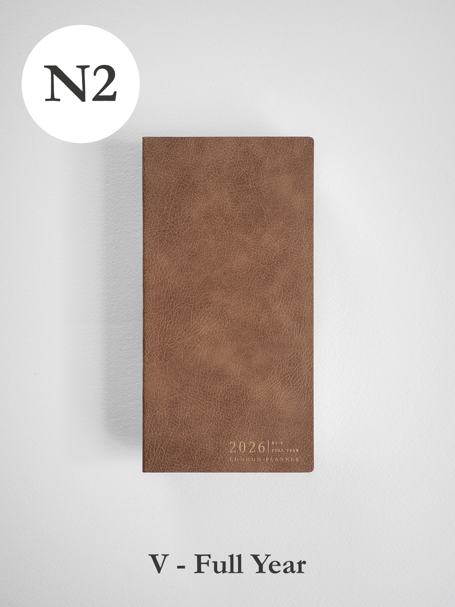 Minimalist full-year planner cover in warm tan faux leather, featuring a simple debossed "2026" marker for easy planning.