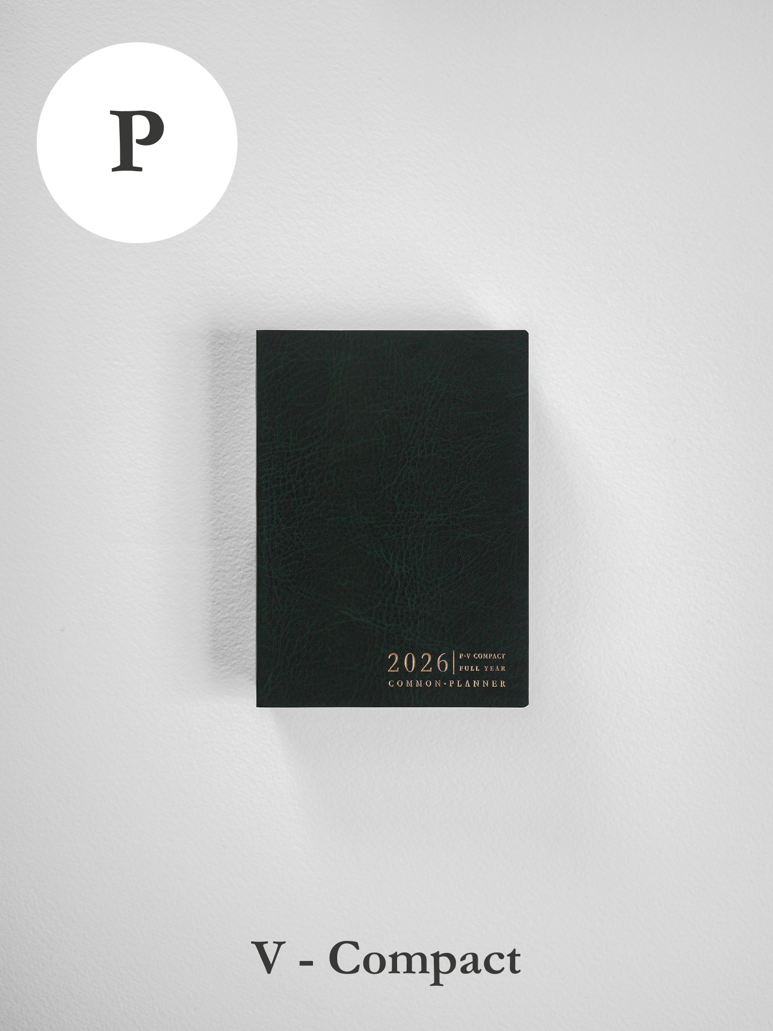 A dark, textured 2026 planner featuring "COMMON PLANNER" embossed in gold lettering on its solid black cover.