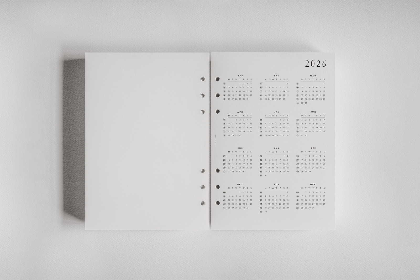 White dated planner inserts displaying organized monthly calendars for 2026, perfect for tracking daily schedules and year-at-a-glance academic or personal planning.