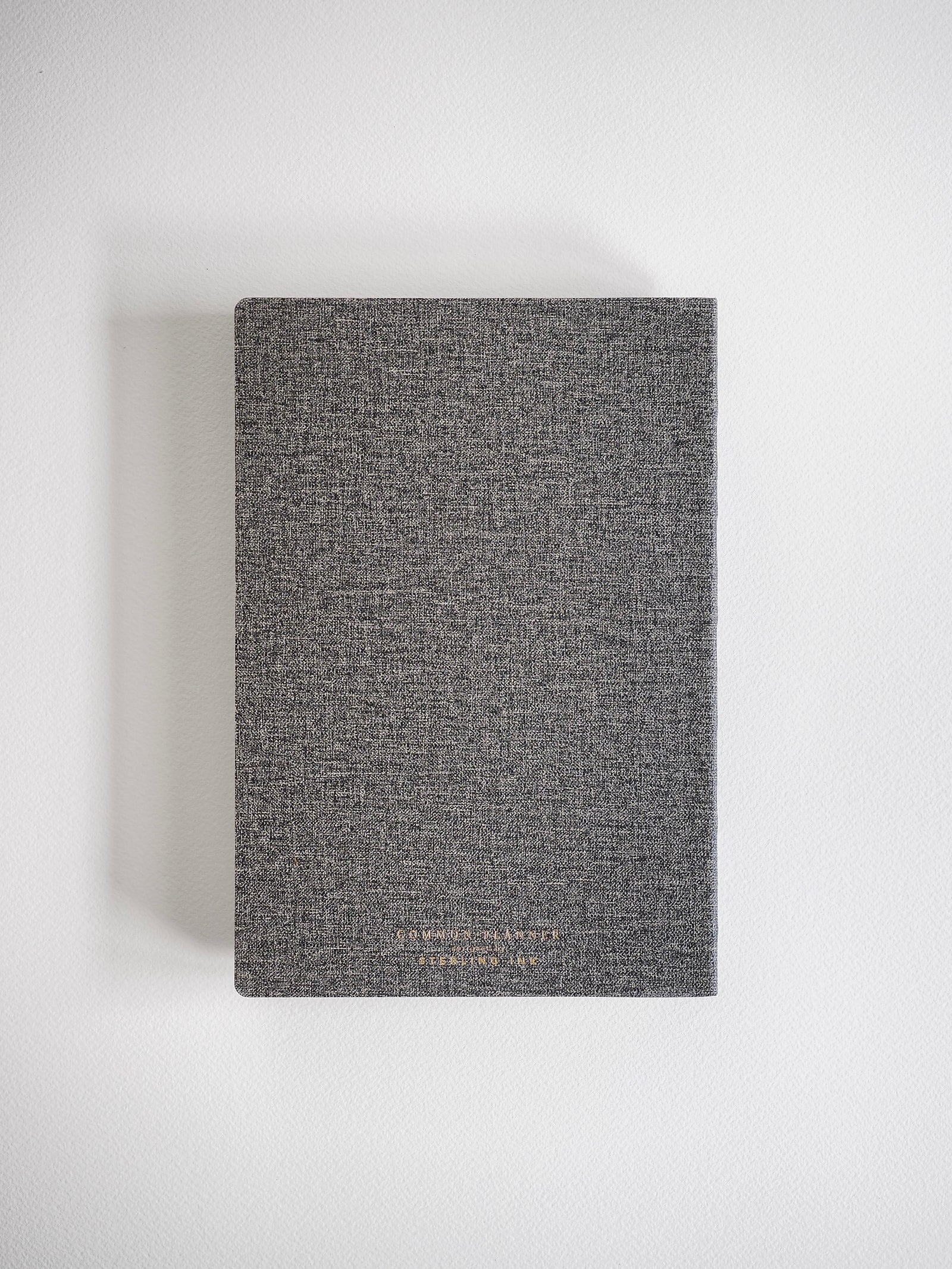A structured A5 horizontal planner cover in heather grey, featuring a subtle branded design perfect for year-long 2026 planning.