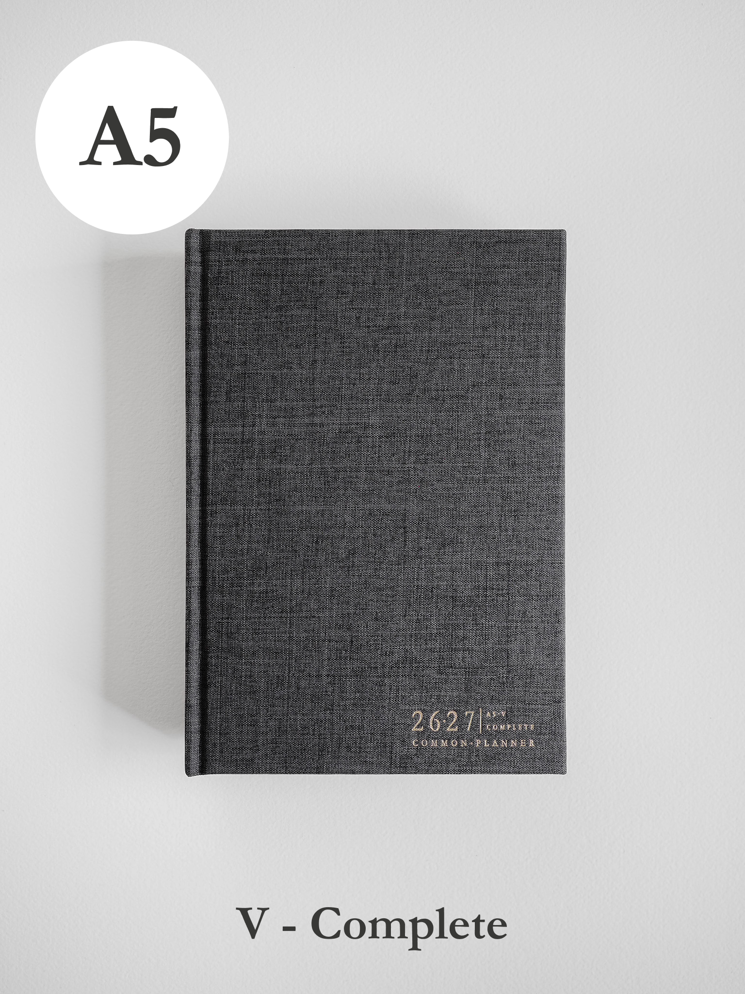 Dark gray A5 academic planner with a textured, durable cover, featuring the printed academic year "2627" and "Common Planner" text.