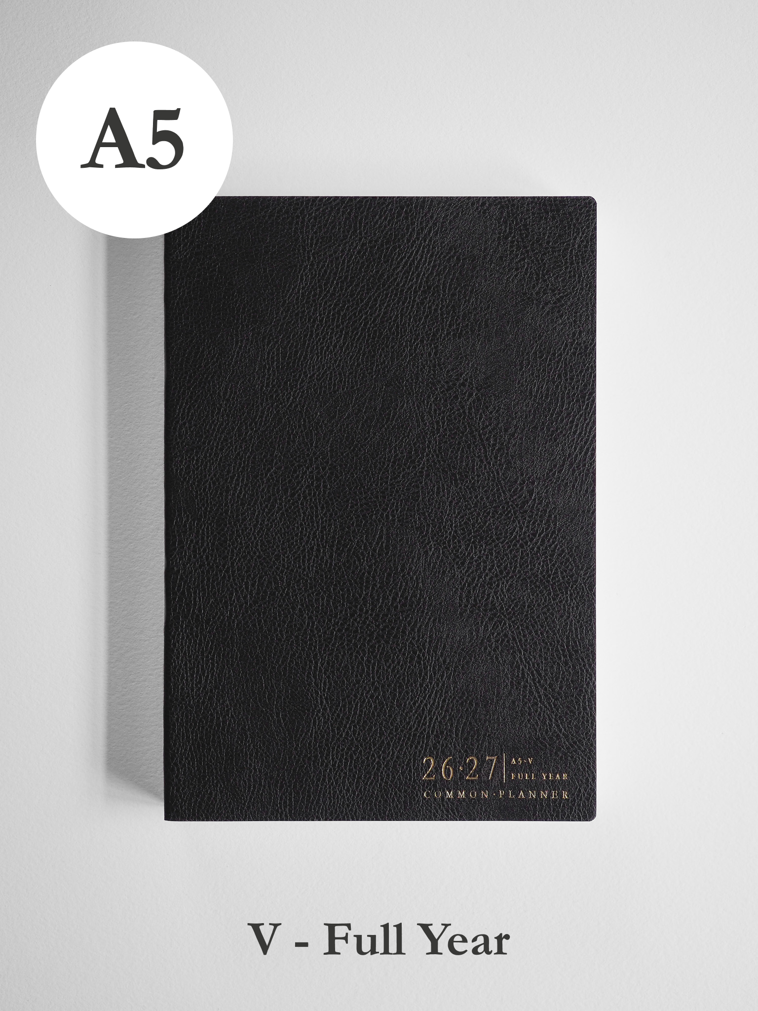 Black A5 vertical academic planner with a faux leather cover, featuring embossed text for the 2026-2027 full year common planner theme.