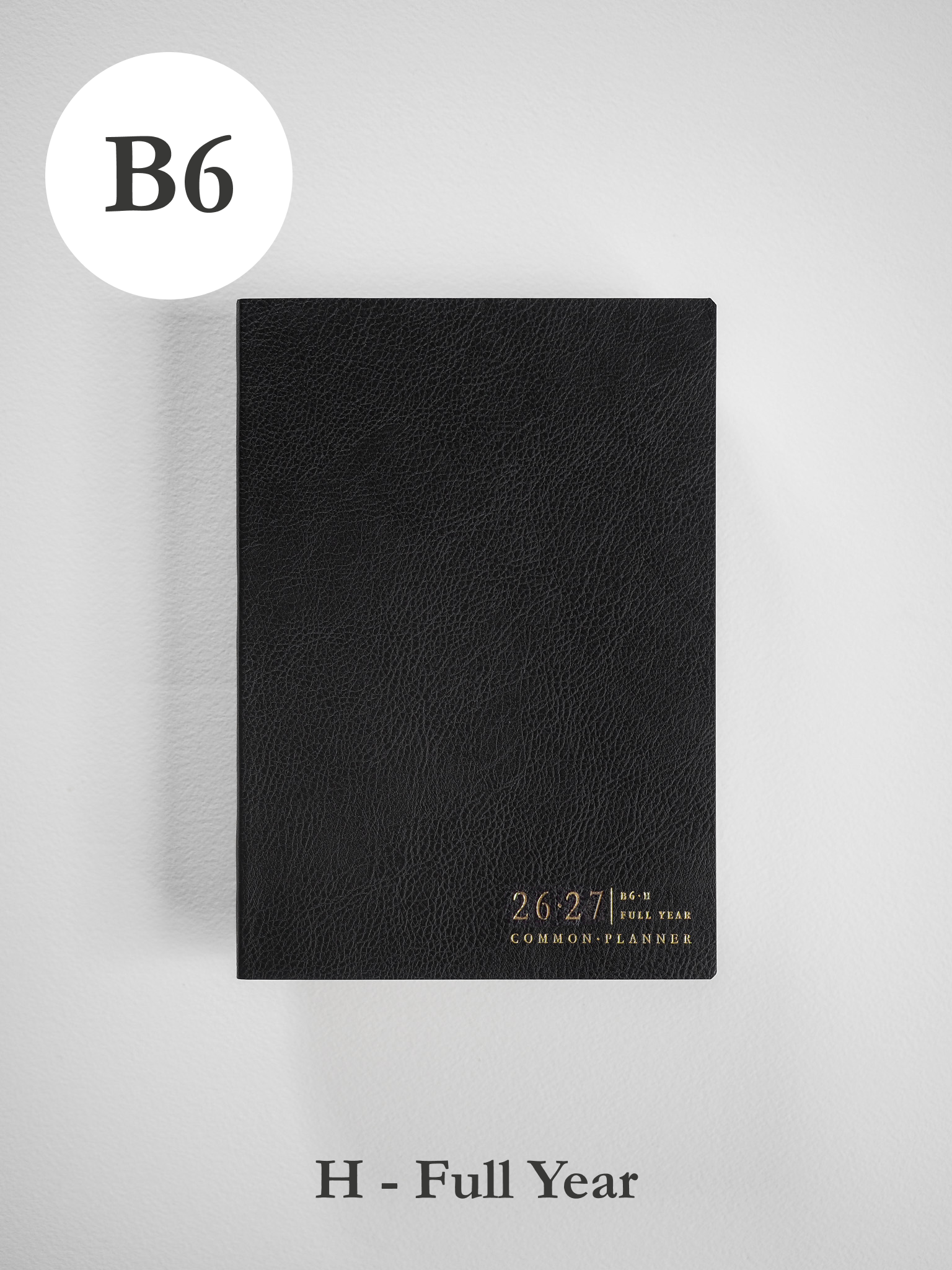 Sleek black B6 academic planner with a textured cover, stamped with the 26-27 academic year and "Common Planner" branding.