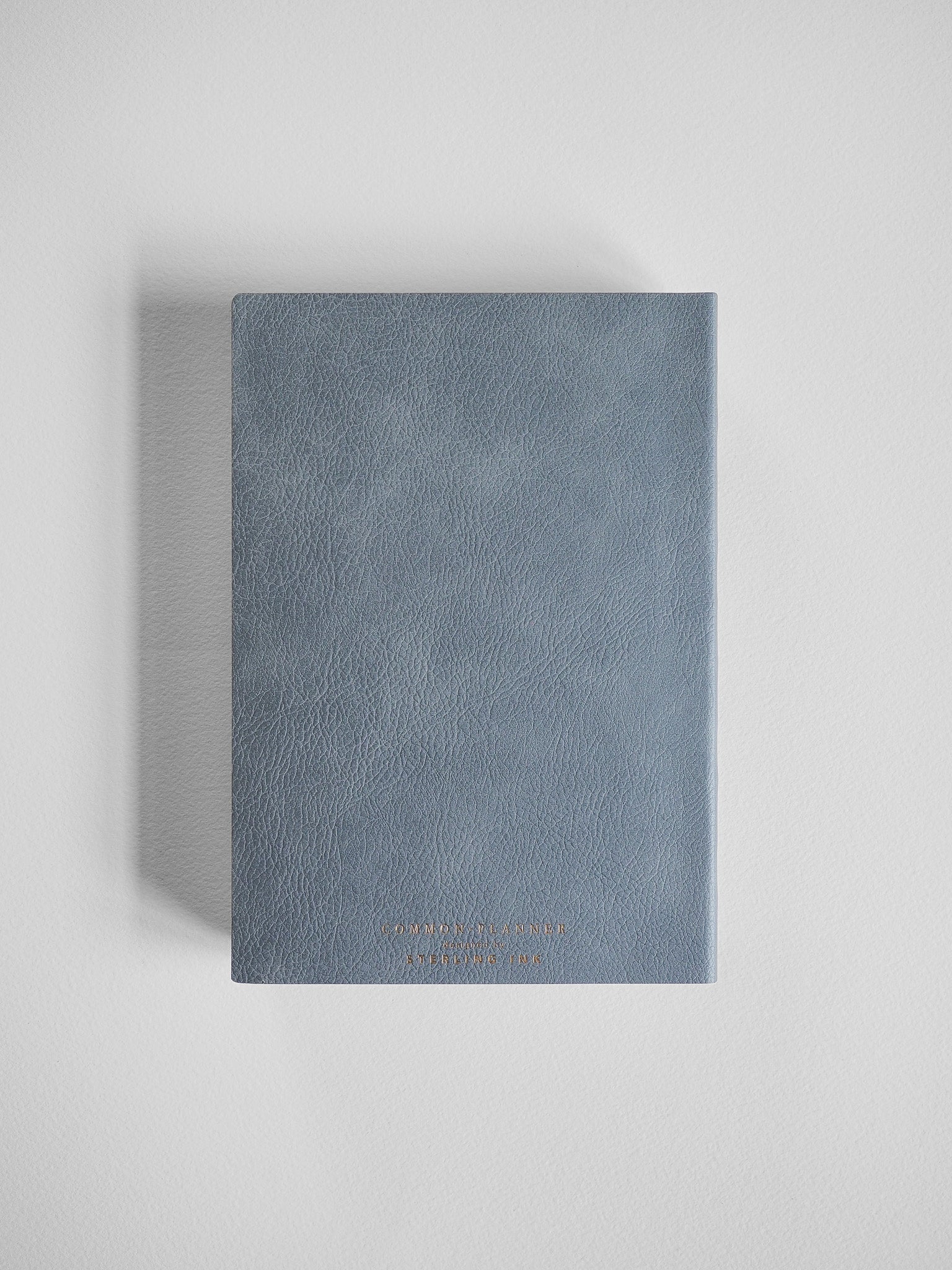 Slate gray B6 vertical common planner with a textured faux leather cover, designed for comprehensive year planning.