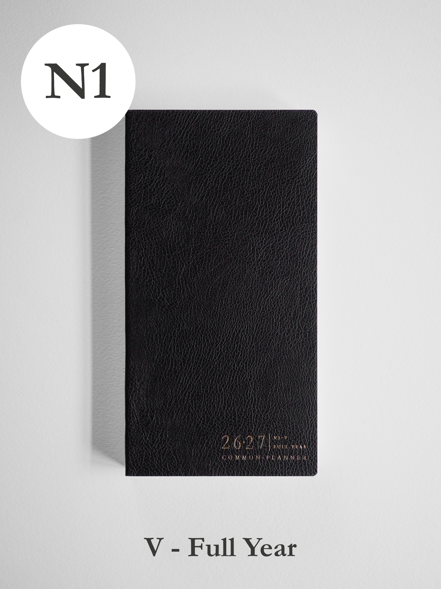 Black vertical academic planner featuring a textured matte cover and subtly debossed gold text identifying the 2026-2027 full year academic year.