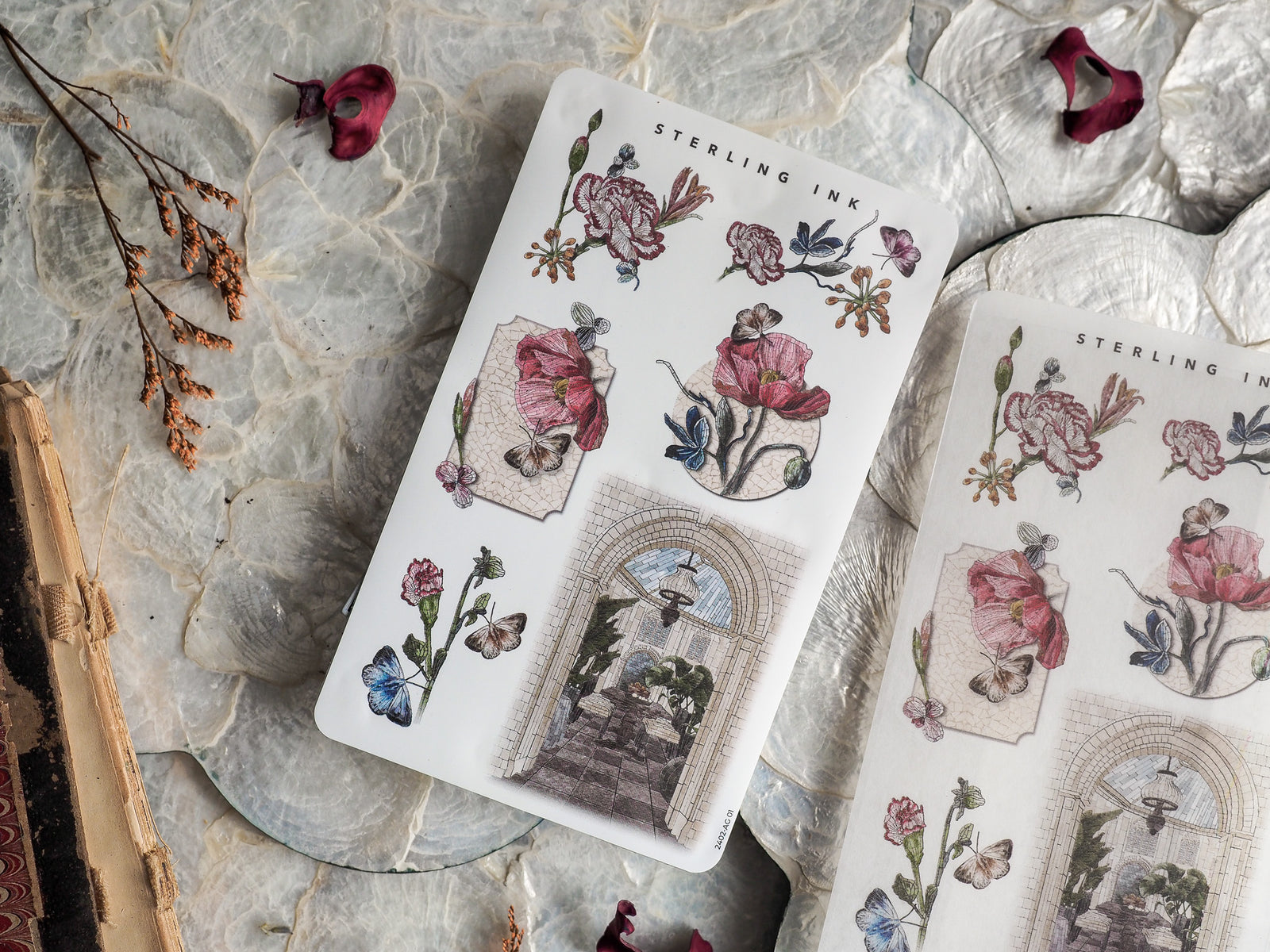 Decorative sticker sheets featuring vintage watercolor illustrations of blooming flowers, butterflies, and antique botanical arrangements in soft pink and blue tones.