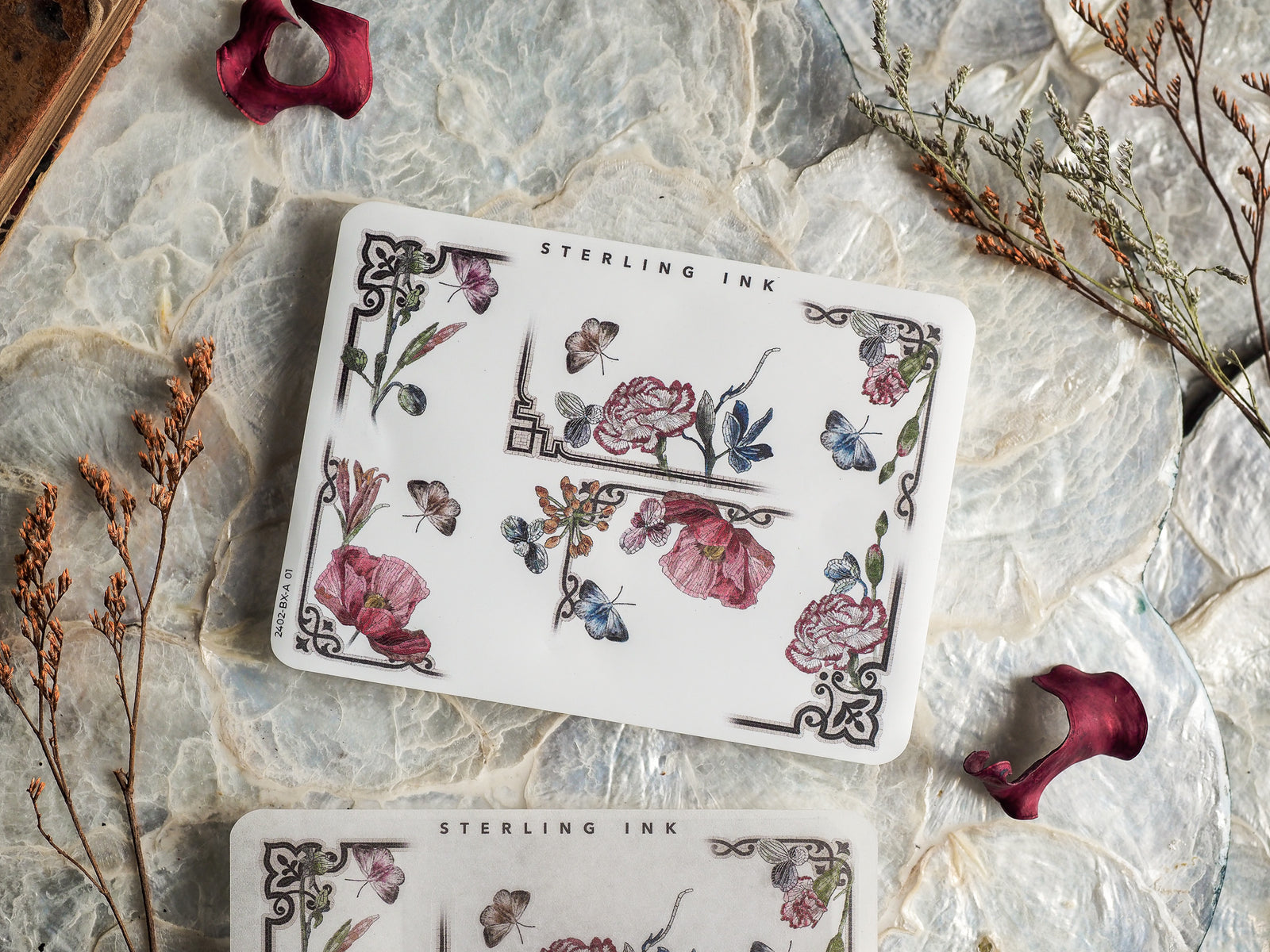 Detailed sticker sheet featuring vintage botanical artwork with blooming flowers, delicate blue butterflies, and elegant black framing borders.