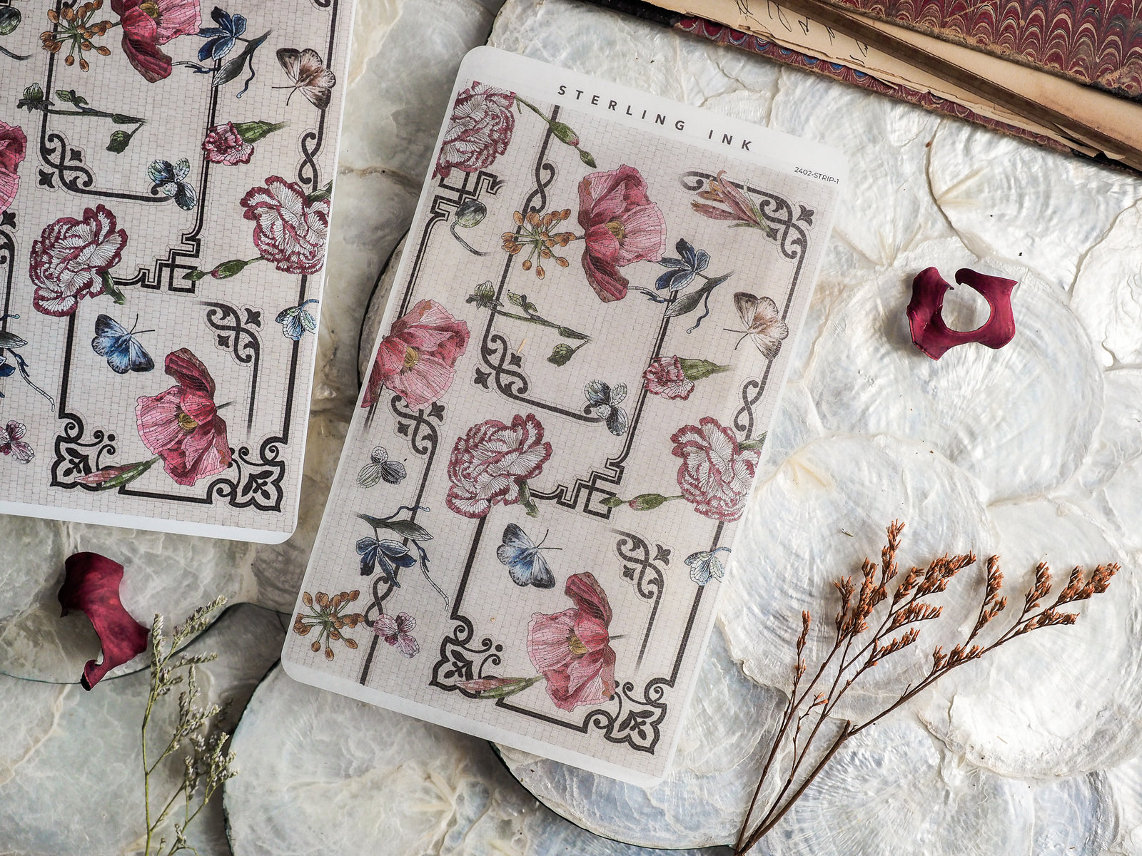 Intricate sticker strips featuring a vintage pattern of delicate pink flowers and blue butterflies set within a geometric lattice design.