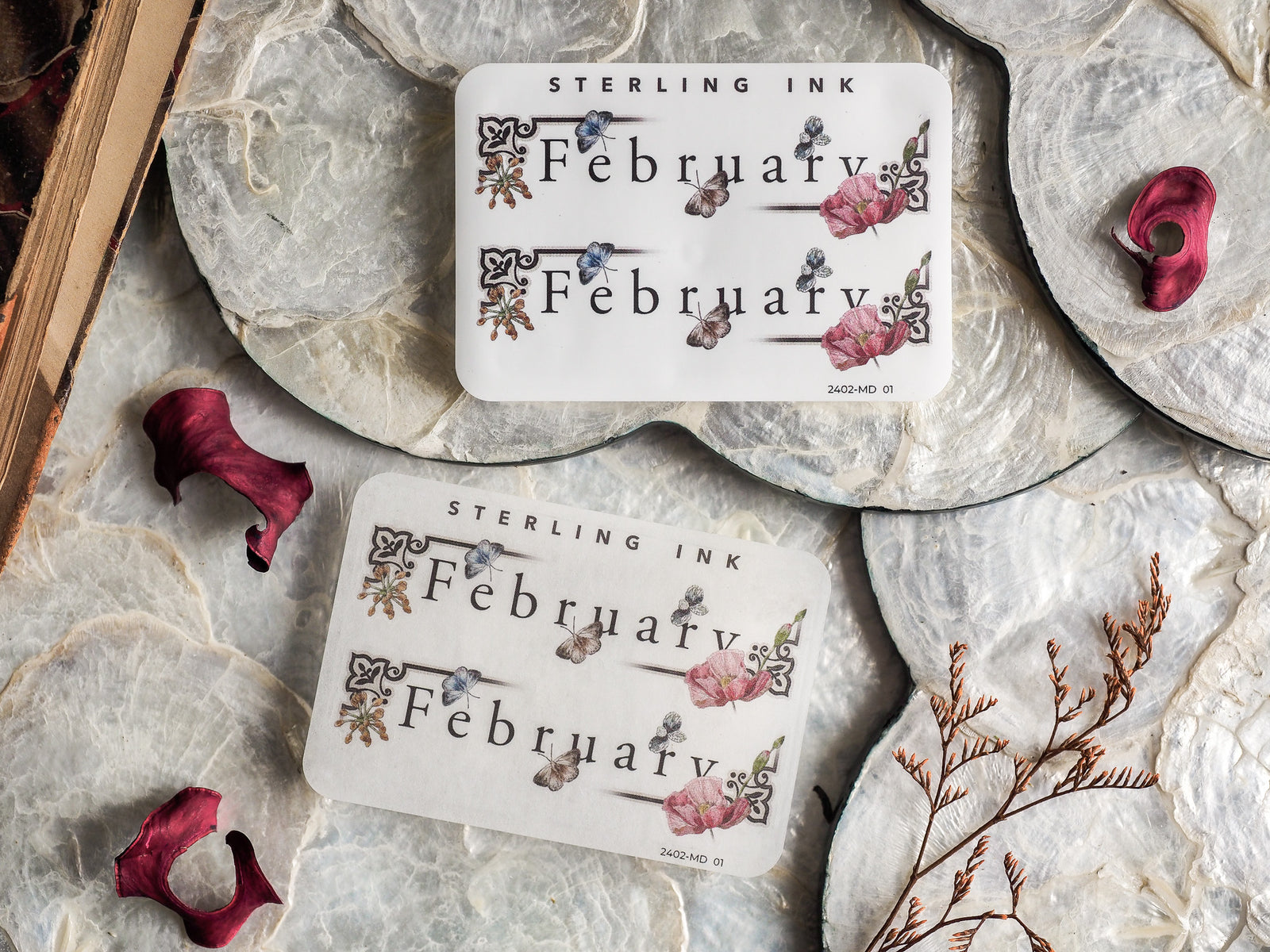 Botanical planning stickers featuring the word 'February' surrounded by delicate pink flowers and rustic natural details.