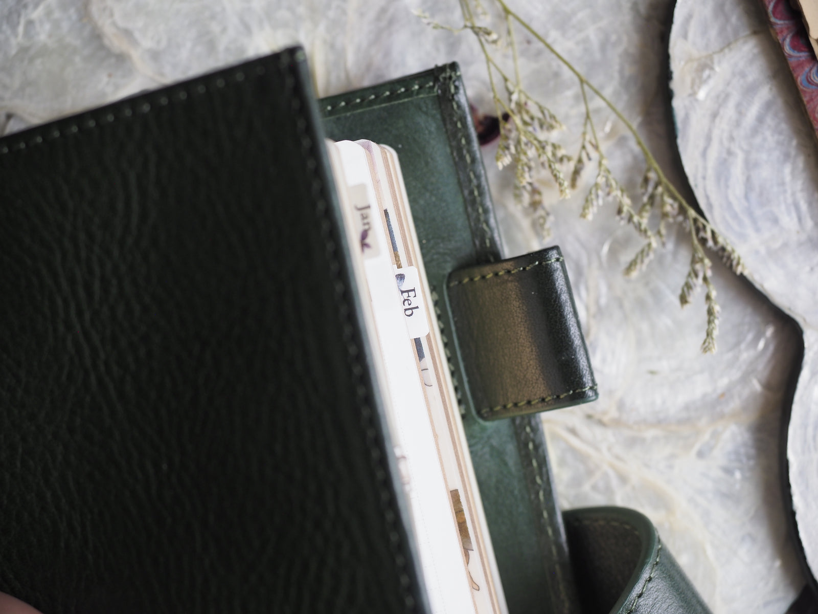A set of coordinating planner tabs featuring January through December, designed for journaling and organization, with a subtle green and white aesthetic.