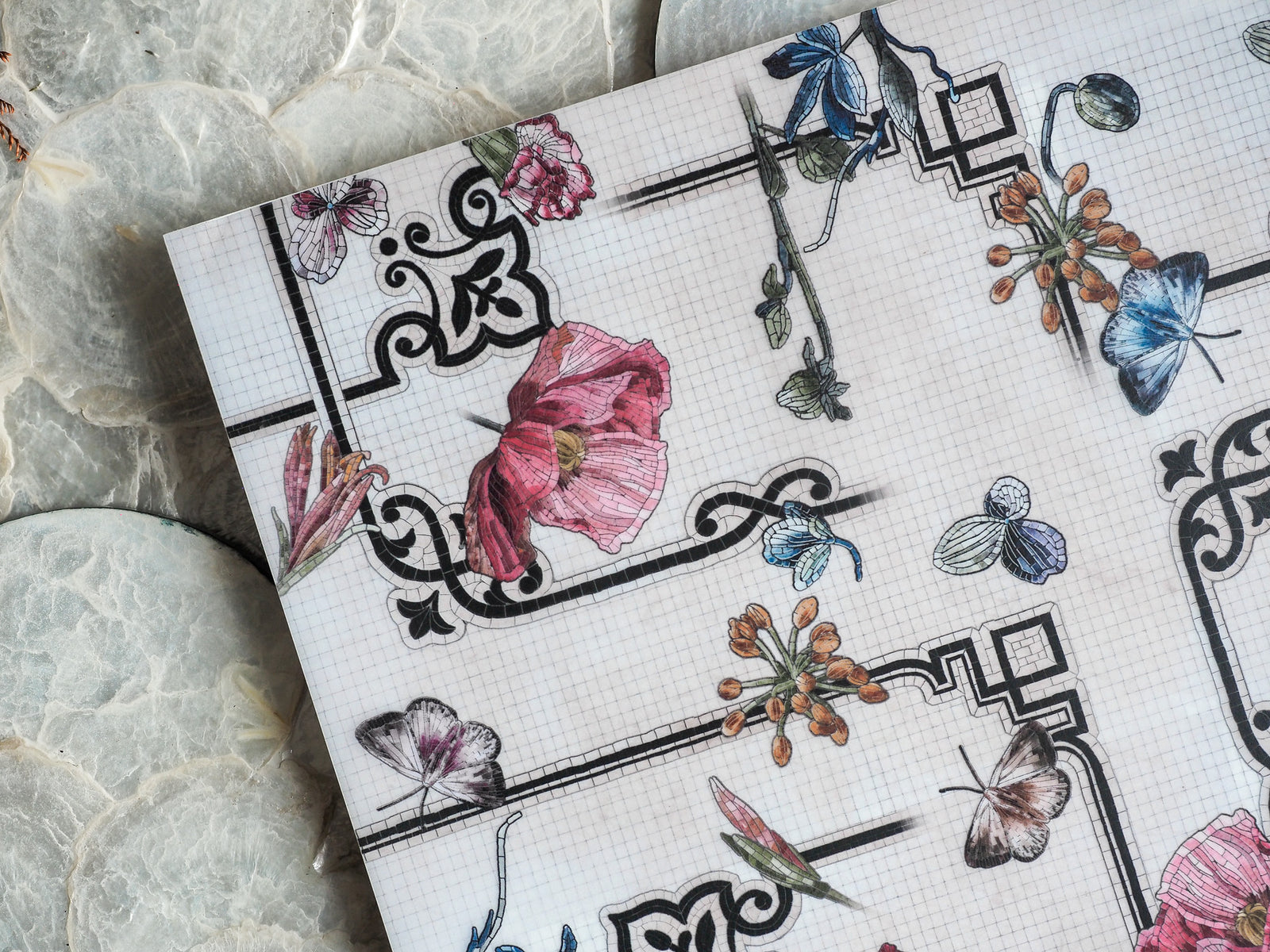 Detailed vintage botanical sheet featuring pink peonies, blue butterflies, and elegant floral motifs printed on graph paper.