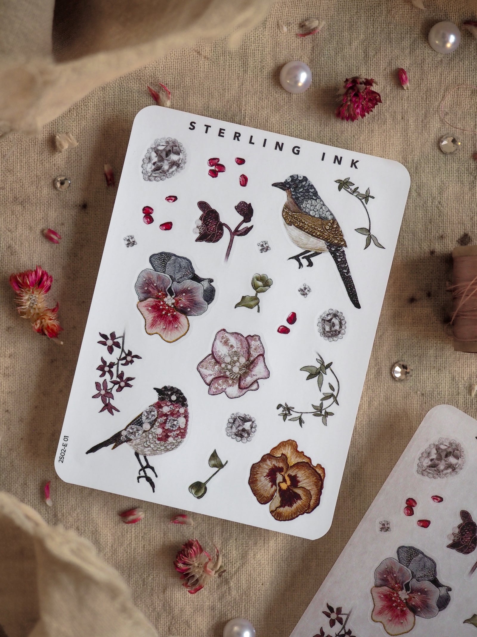 Botanical sticker kit featuring detailed illustrations of anthurium flowers, assorted blossoms, small leaves, and a richly detailed sparrow bird.