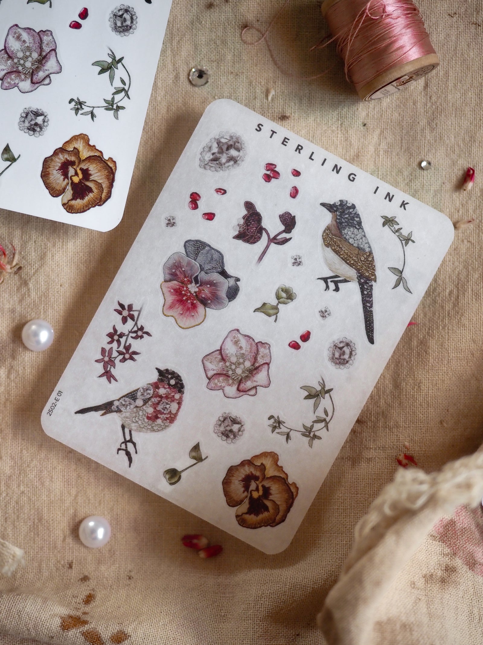 Botanical sticker sheet featuring delicate printed elements like detailed orchids, wildflowers, leaves, and birds arranged in a natural, vintage, and highly aesthetic pattern.