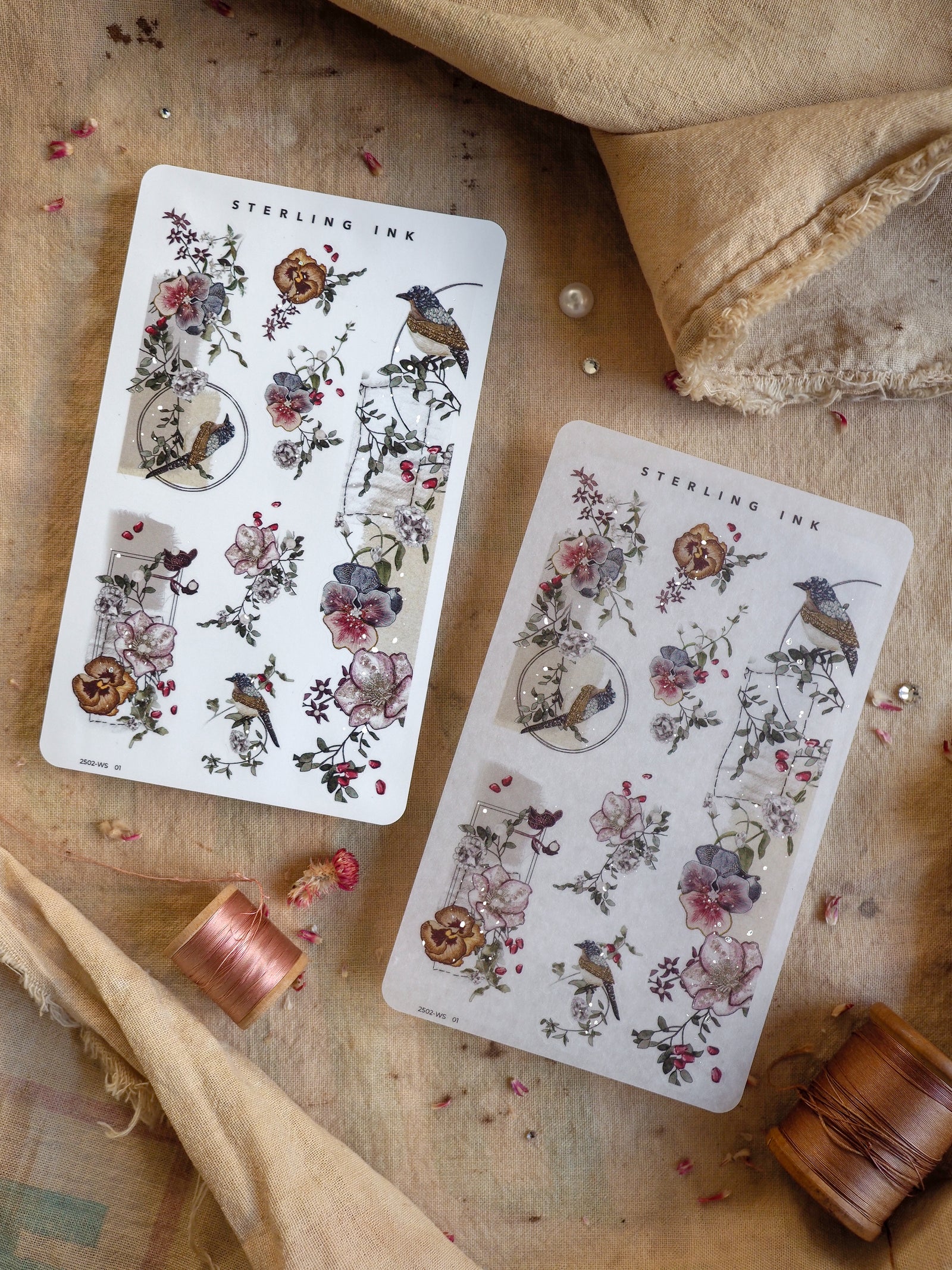Elegant washi stickers featuring detailed botanical illustrations of blush flowers, foliage, and small woodland birds, printed with a delicate silver foil finish.