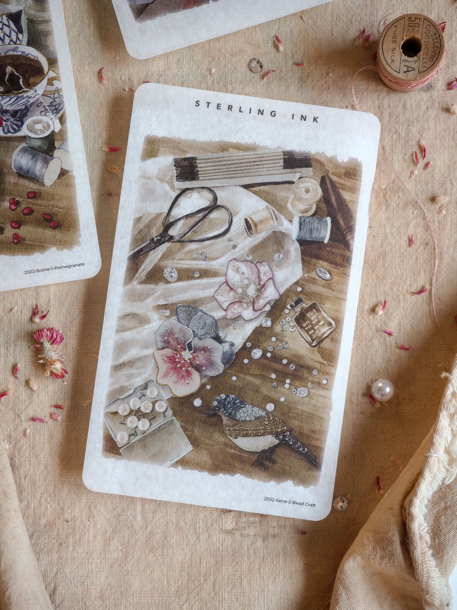 Detailed single scene sticker featuring vintage bead crafting tools, spools, and miniature floral elements surrounding a small bird.