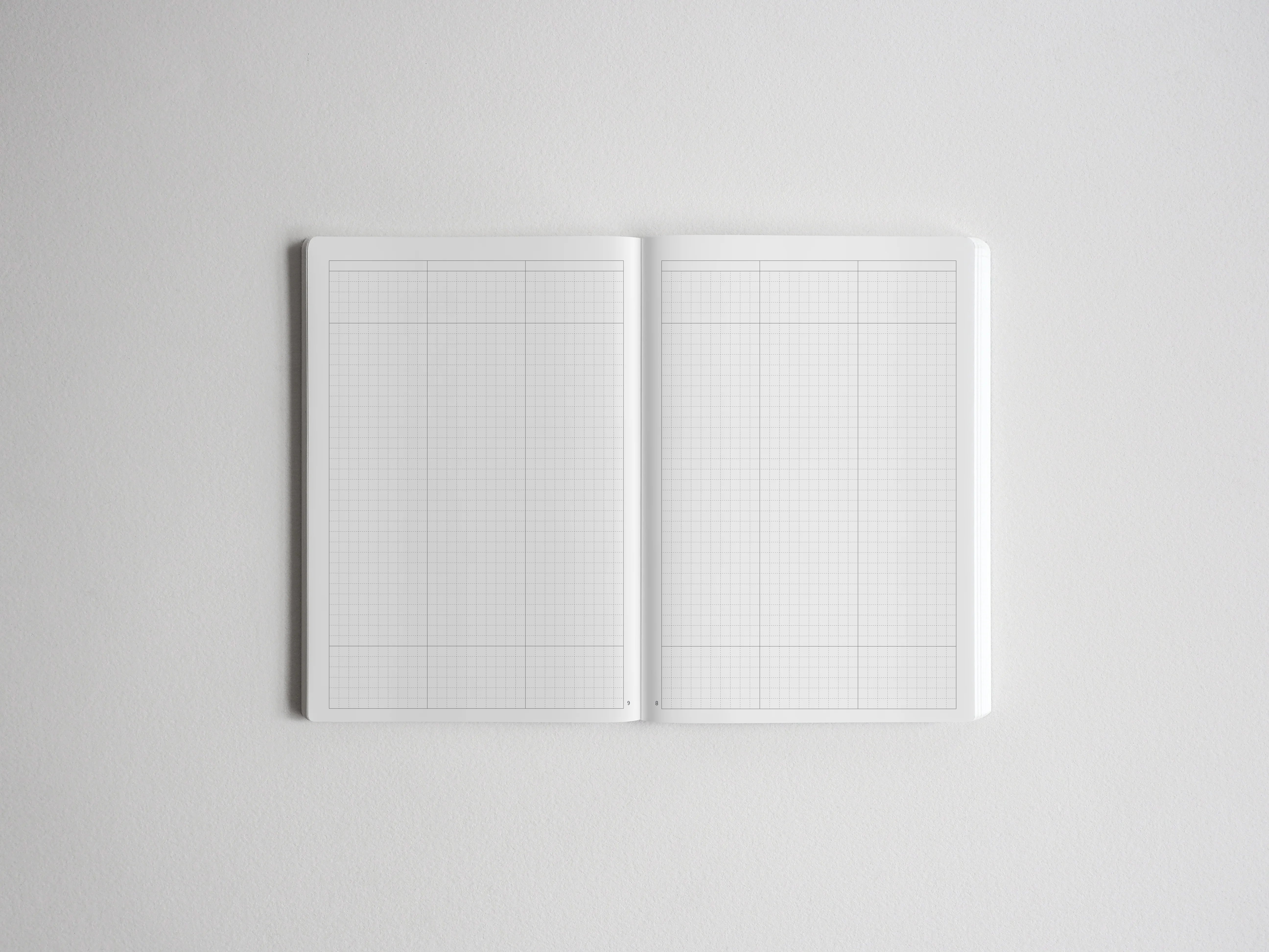 Open spiral sketchbook displaying pristine graph paper grids, ideal for technical drawing, precise journaling, or architectural planning.