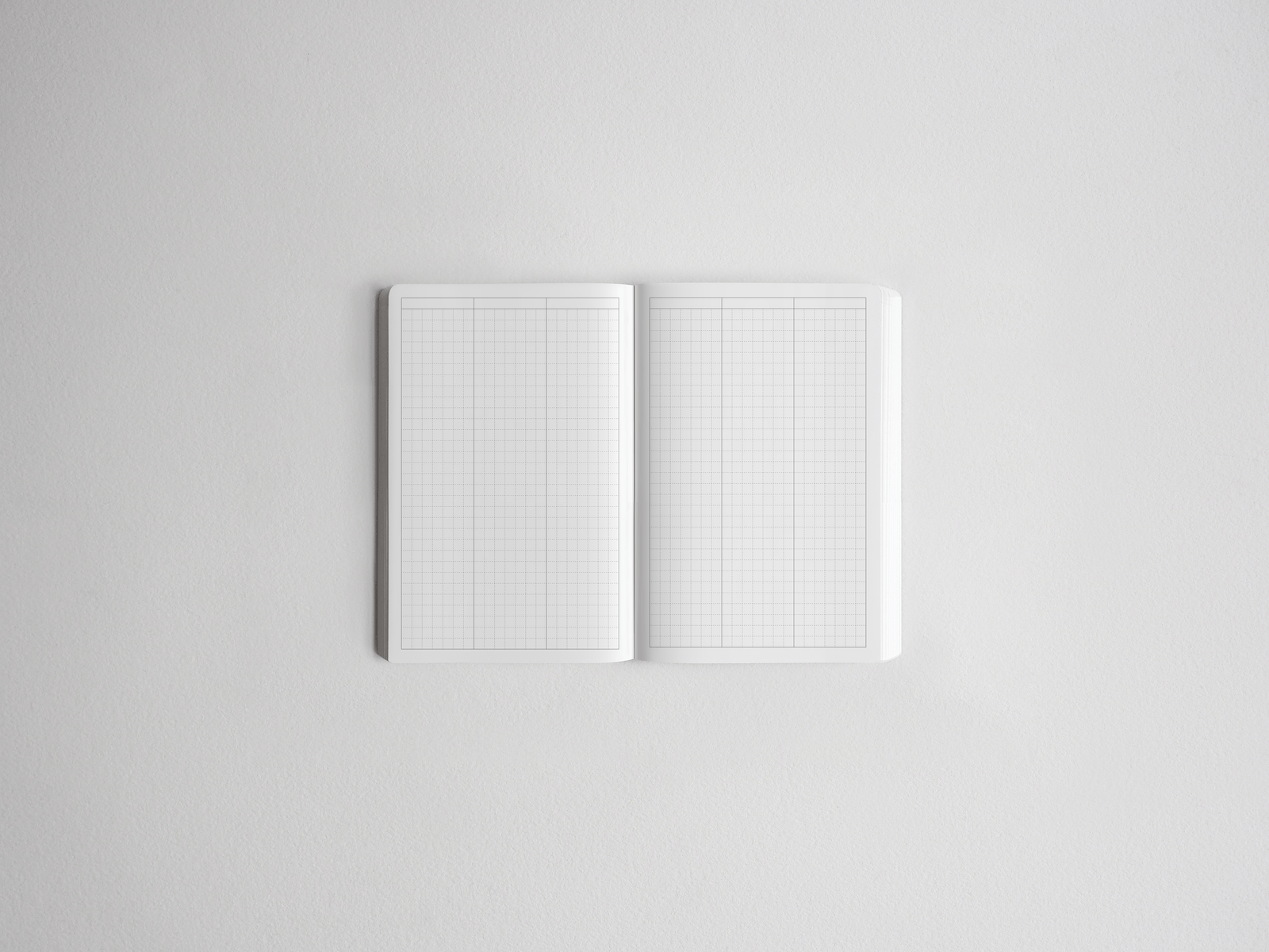 Open sketchbook featuring double-page graph paper, displaying precise grid lines ideal for technical drawing, journaling, or academic planning.