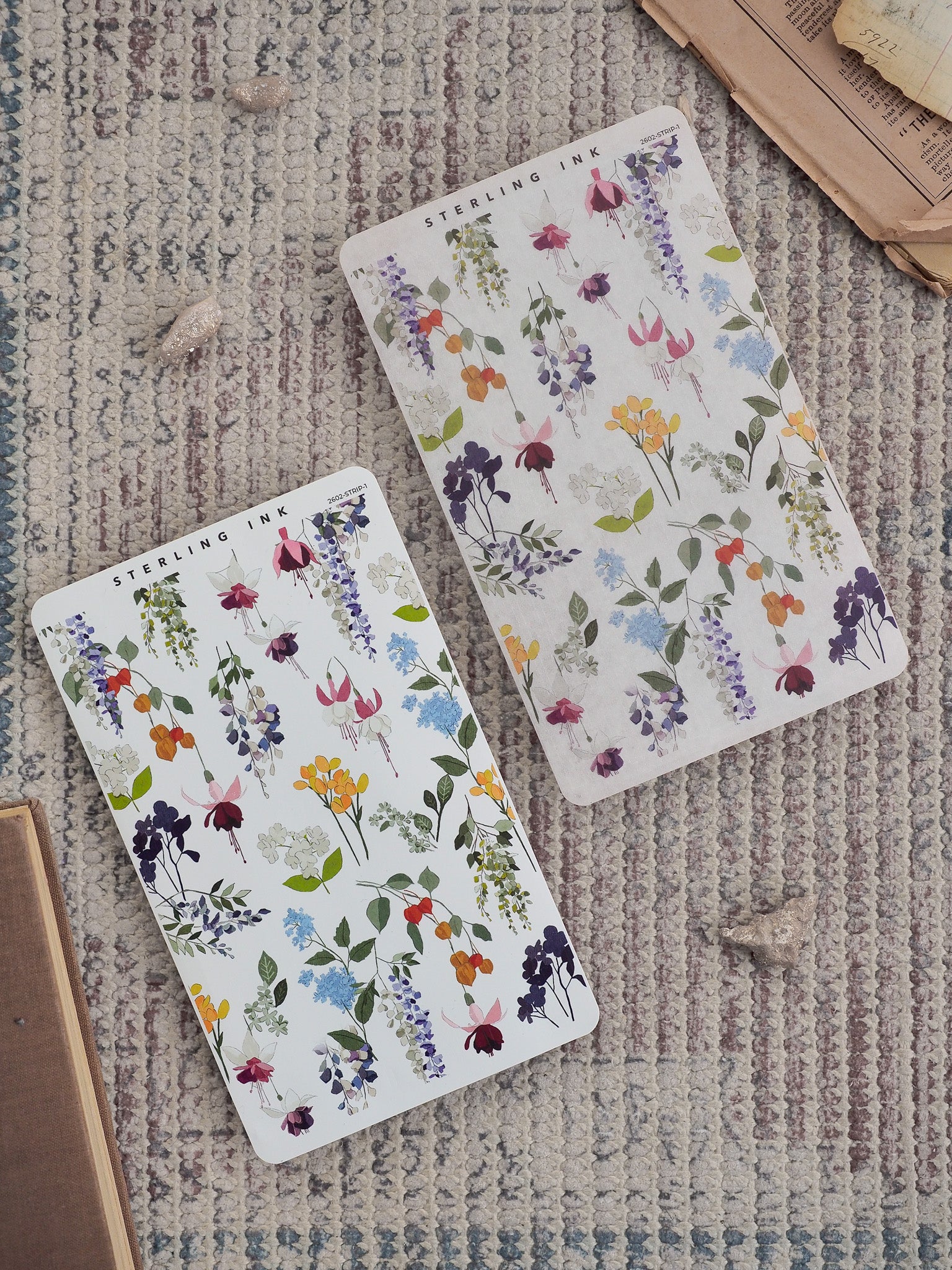 Watercolor-style sticker sheets featuring a romantic, dense floral pattern of purple, pink, and yellow blossoms mixed with vibrant green foliage.