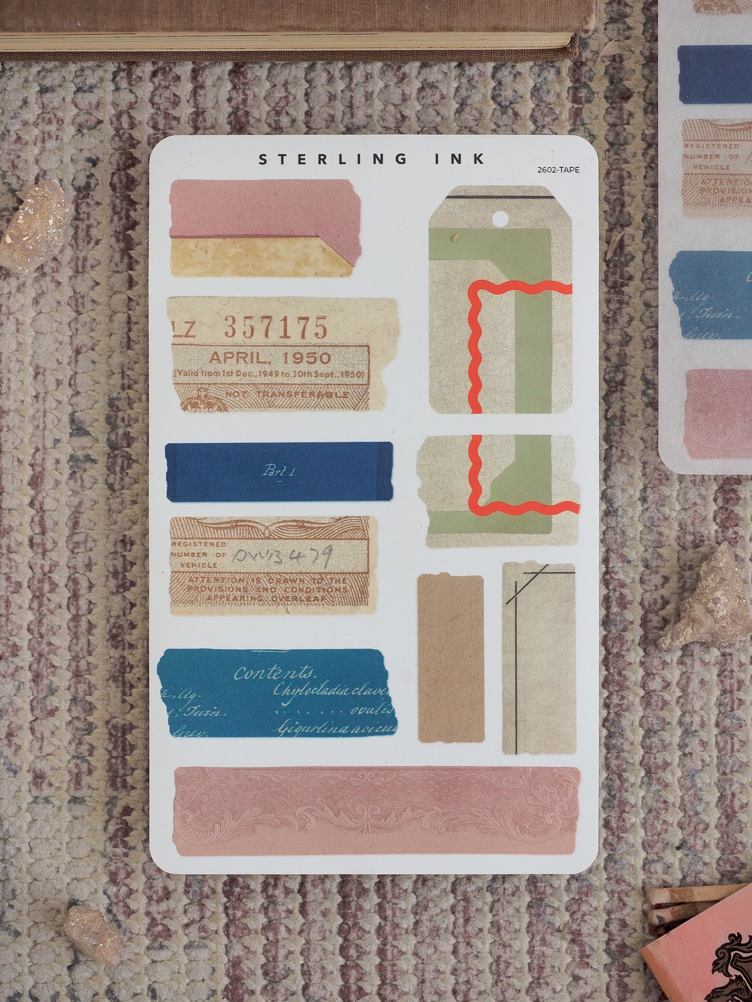 A sheet of vintage archival sticker ephemera, featuring torn tape strips and faux ink labels in beige, green, and pink for journaling and crafting.