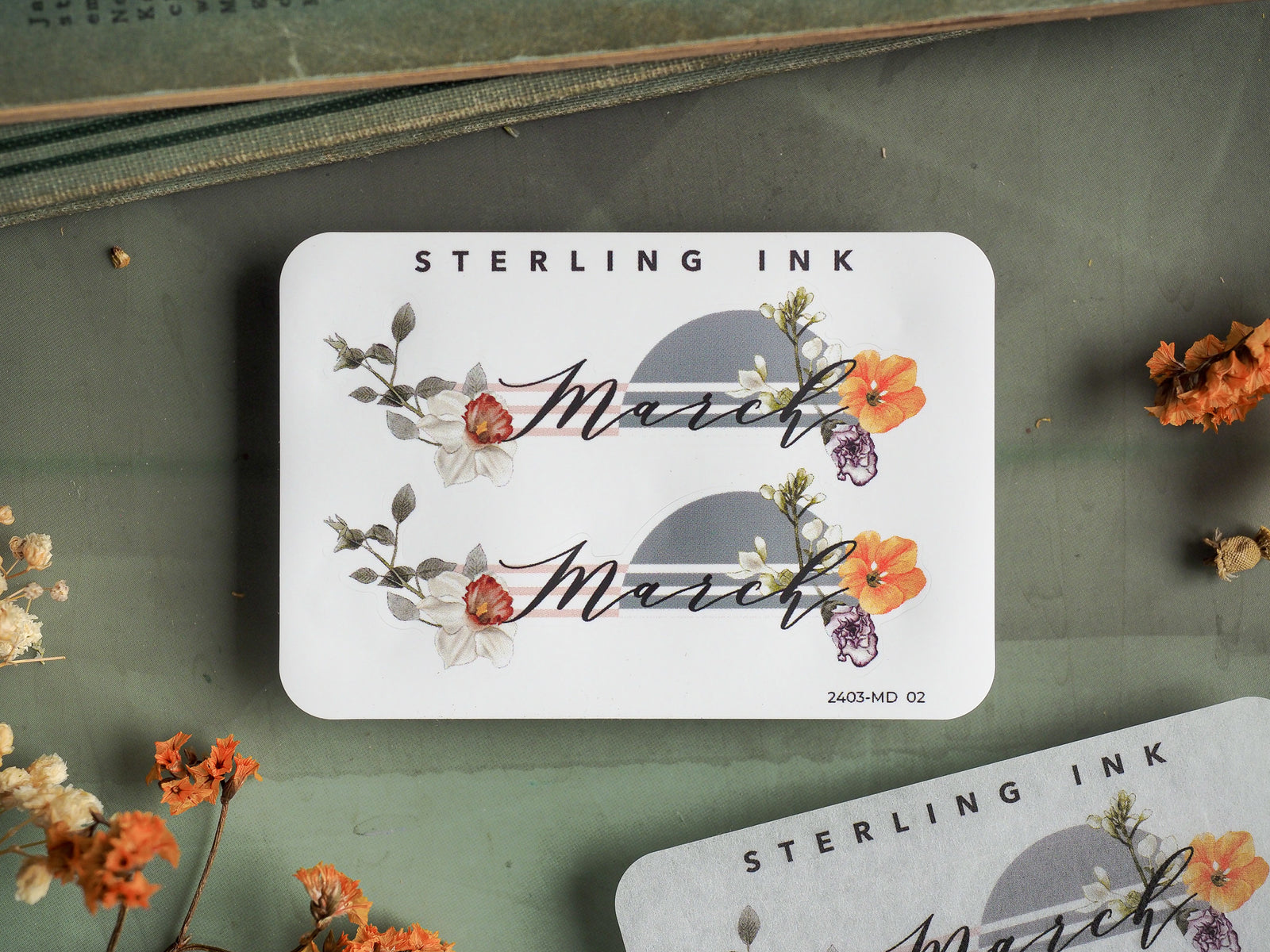 Elegant "March" month sticker featuring botanical watercolor blooms and greenery in warm autumn colors on a crisp white background.