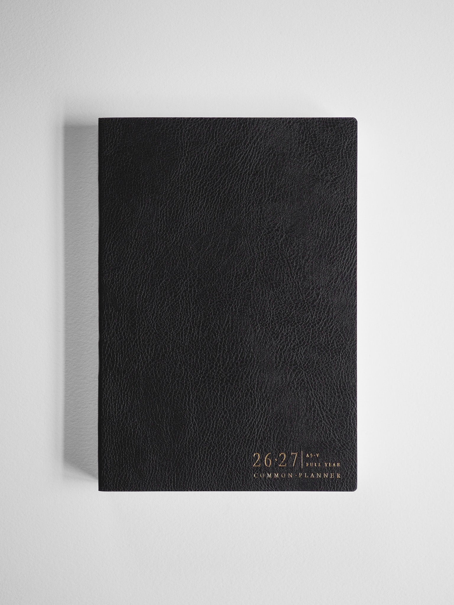 Sleek black A5 academic planner cover, embossed with the 2026-2027 Common Planner text, designed for full-year organizational planning.