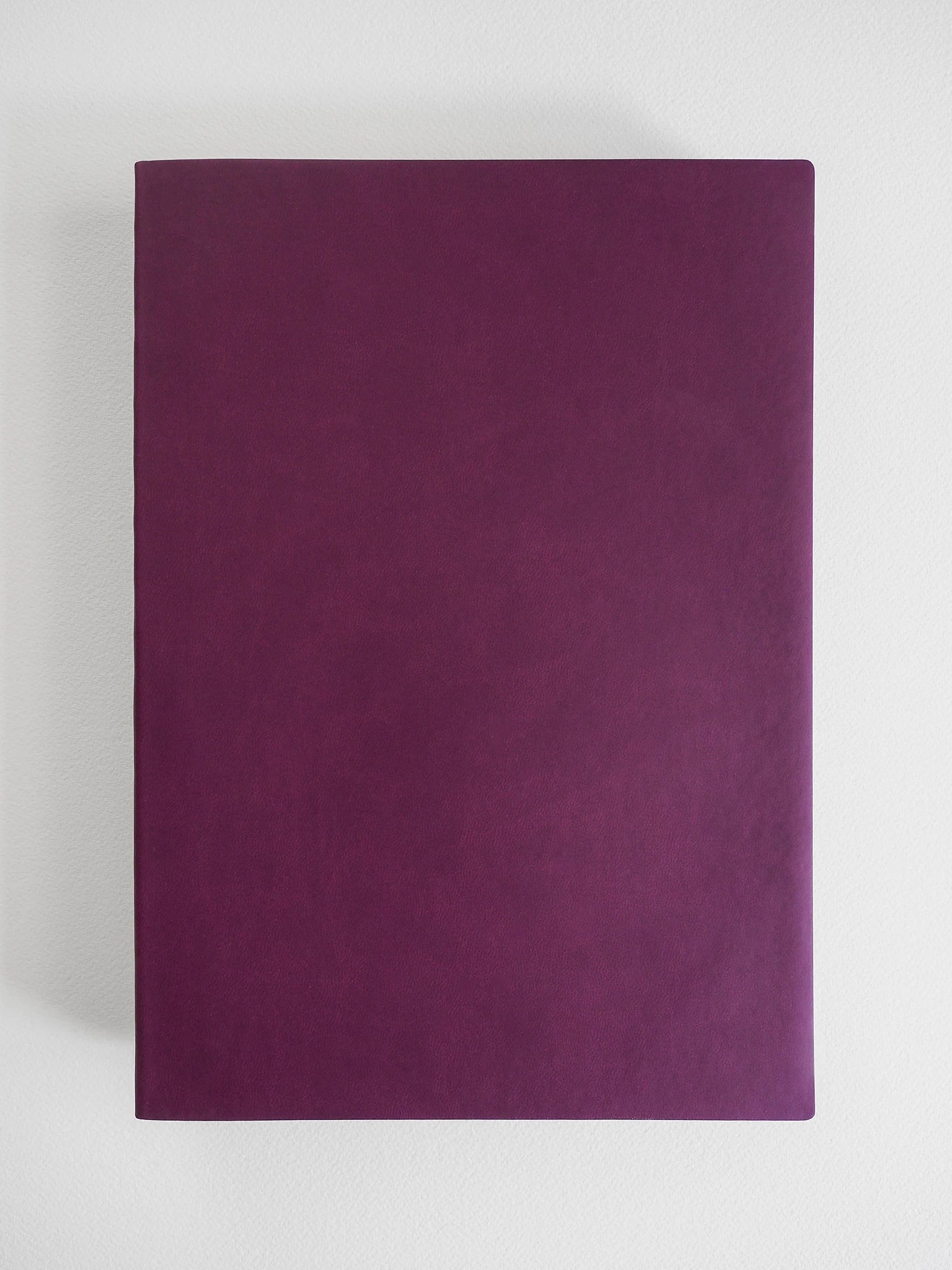 A dark purple textured leather or faux-leather notebook cover, standing vertically against a light gray background.
#Color_Mulberry