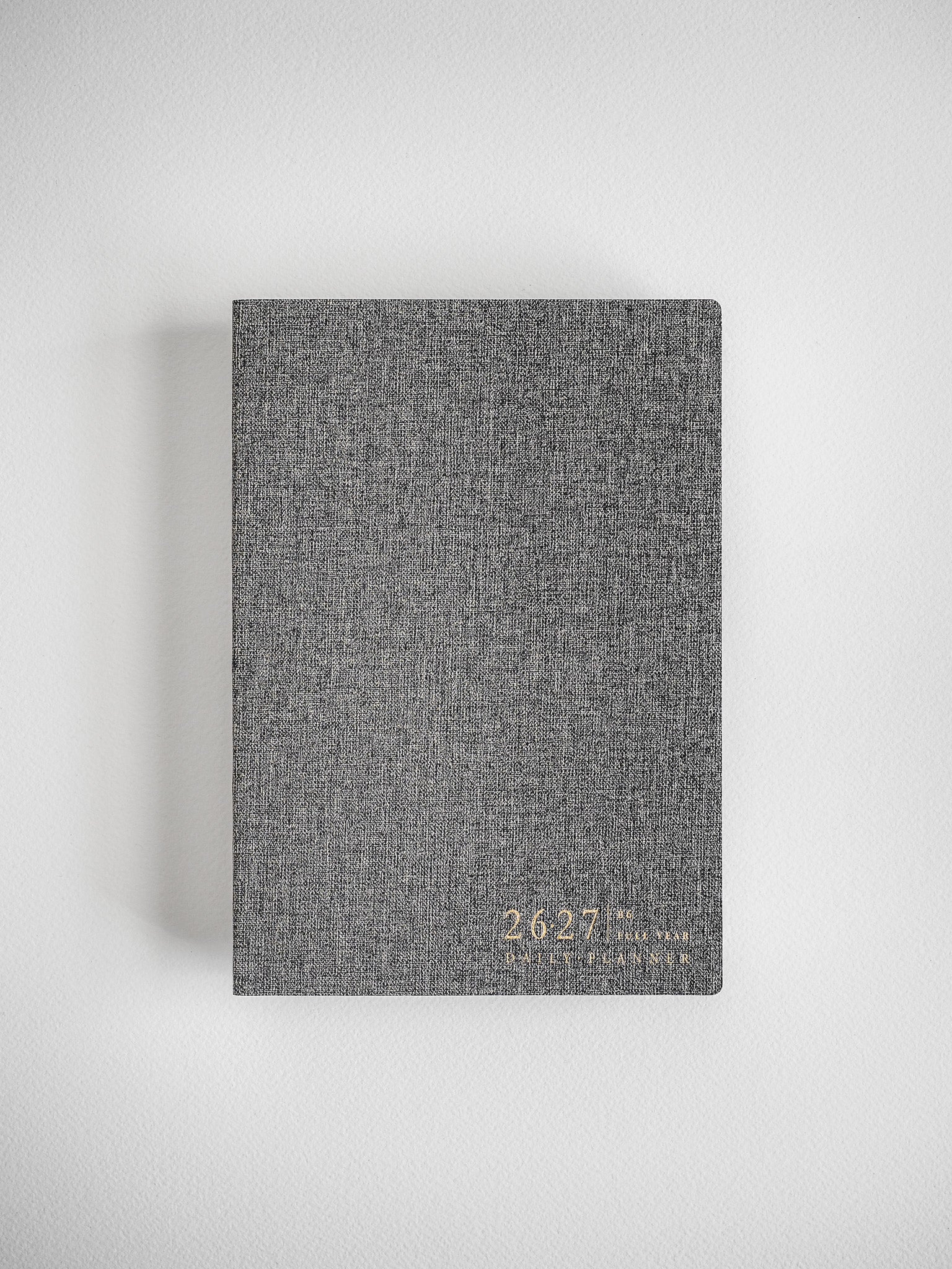 Textured B6 daily planner with a charcoal gray woven cover, clearly displaying the "2026-2027" academic year dates for organization.