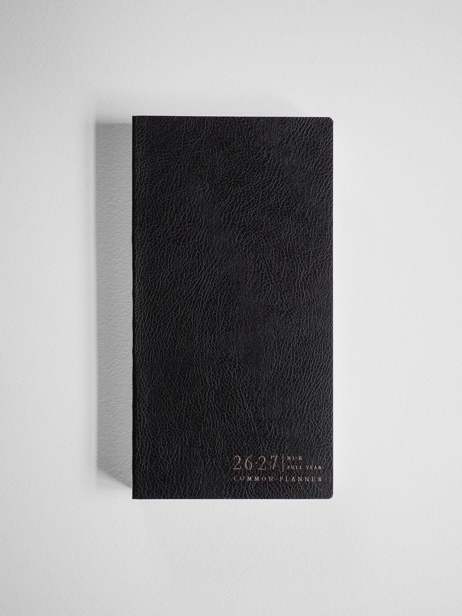 Black, textured academic planner cover for the 2026-2027 full year, featuring elegant gold lettering identifying the Common Planner branding.