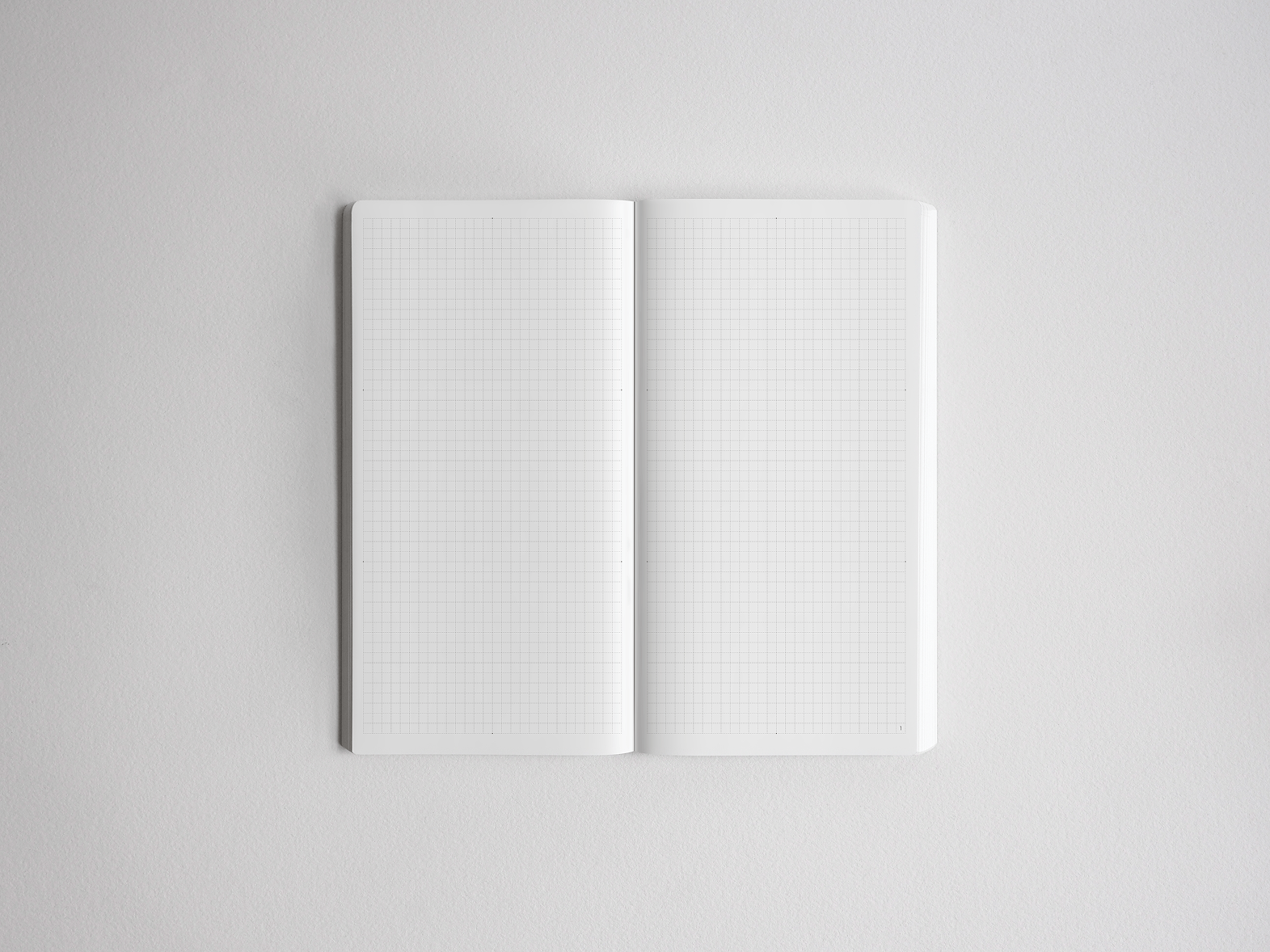 Open notebook displaying 272 pages of graph paper featuring precise, uniform light gray grid lines, ideal for detailed note-taking, drawing, or study planning.
