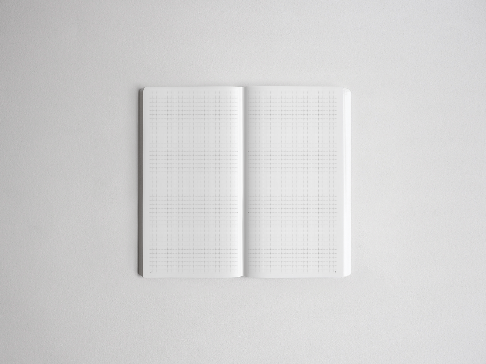 Open spiral-bound notebook showing two pristine pages covered in uniform, precise graph paper grids, perfect for technical notes or drawing.