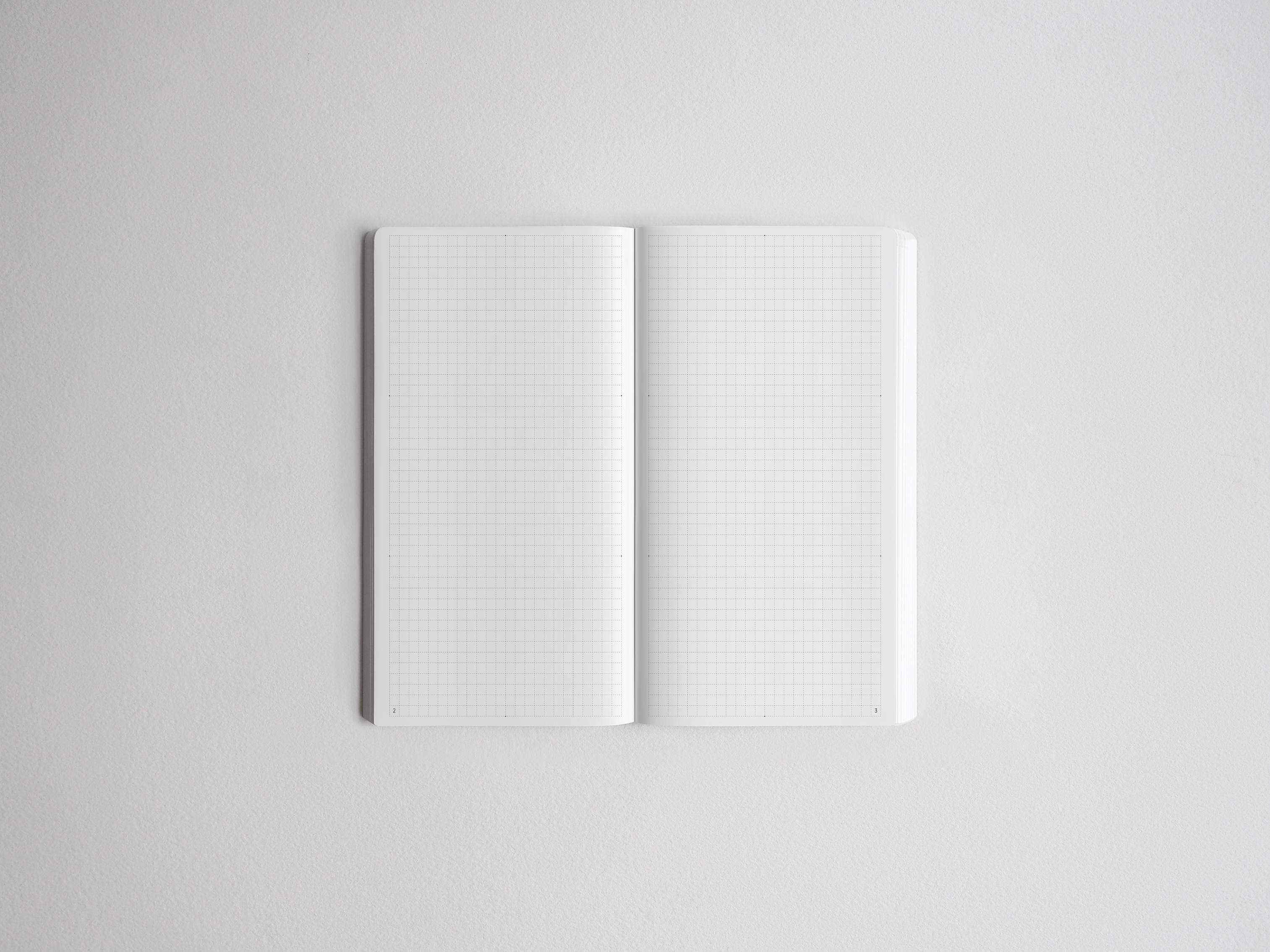 Open spiral-bound notebook showing two pristine pages covered in uniform, precise graph paper grids, perfect for technical notes or drawing.