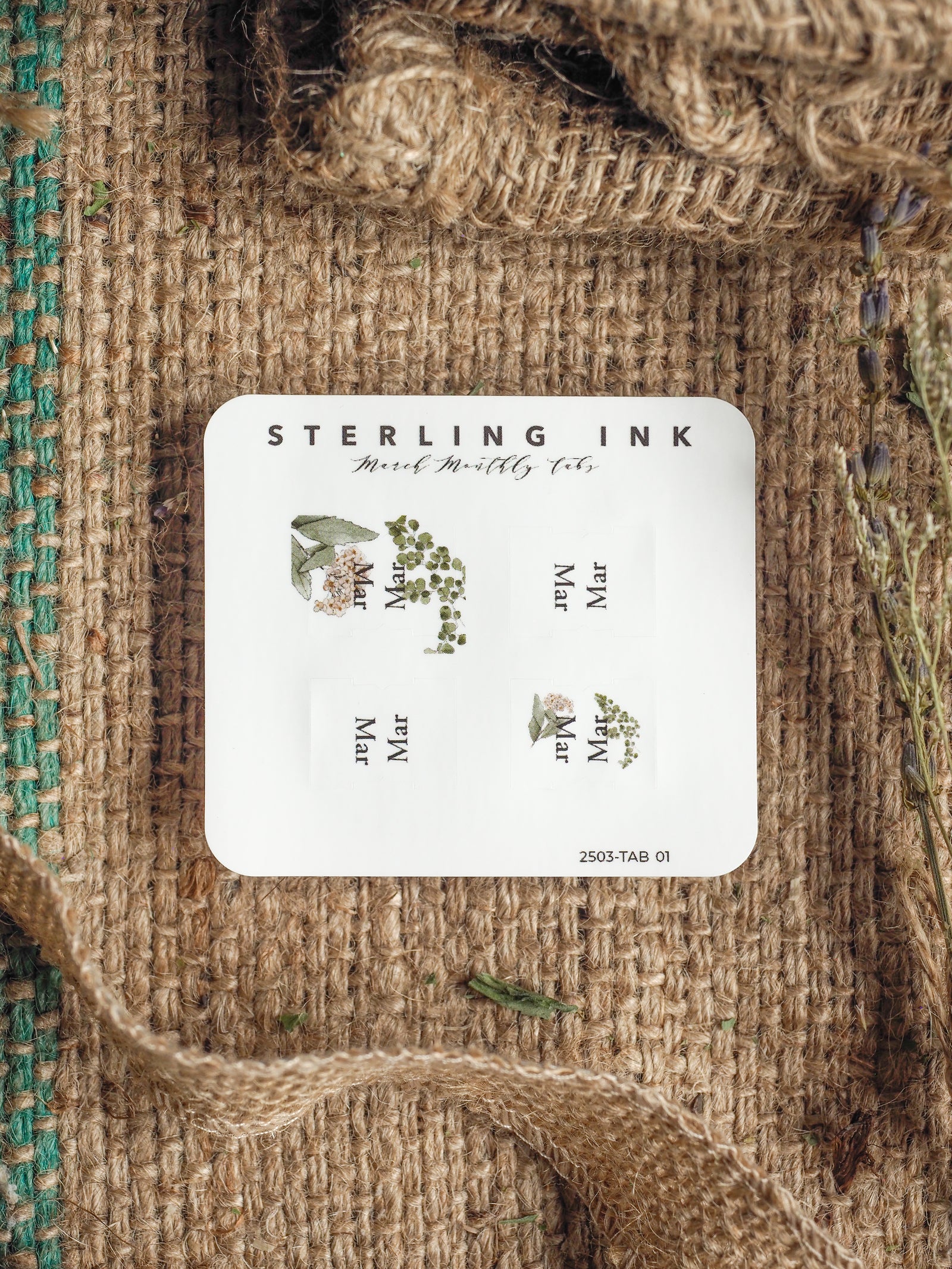 White planning tabs from Sterling Ink, designed with a delicate botanical theme, featuring clusters of green leaves and soft floral illustrations perfect for March organization.
