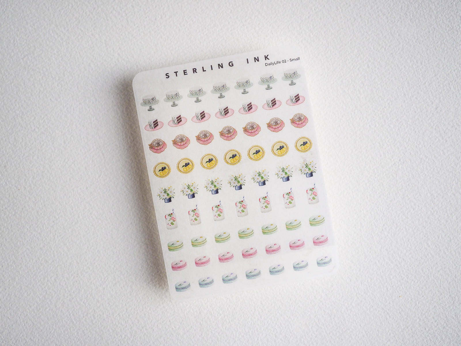 Cute watercolor sticker sheet featuring mini cupcakes, donuts, potted plants, and sweet pastries in a pastel, cottagecore
