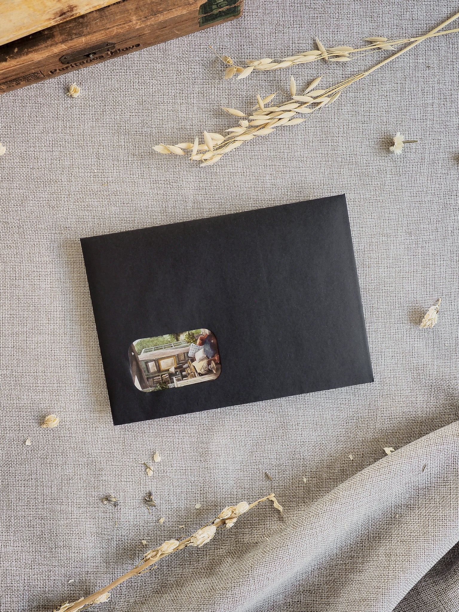 Sleek black card sleeve featuring a warm, nostalgic photograph of people enjoying an outdoor cafe setting, marking the March 2026 subscription kit.