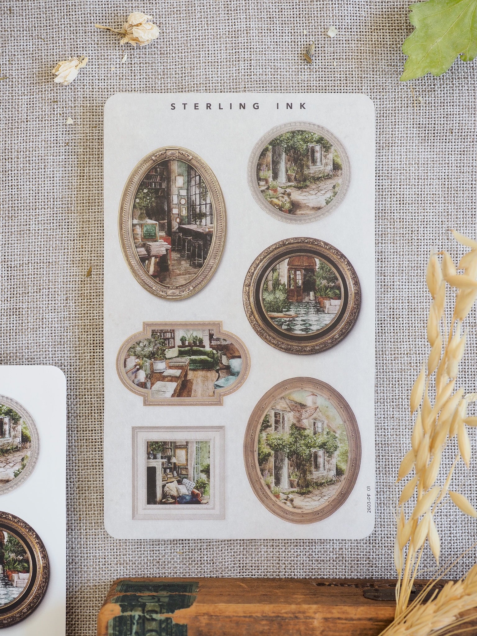 Vintage sepia-toned picture frame stickers featuring architectural sketches of rustic houses, charming gardens, and historical scenes from the March 2026 collection.