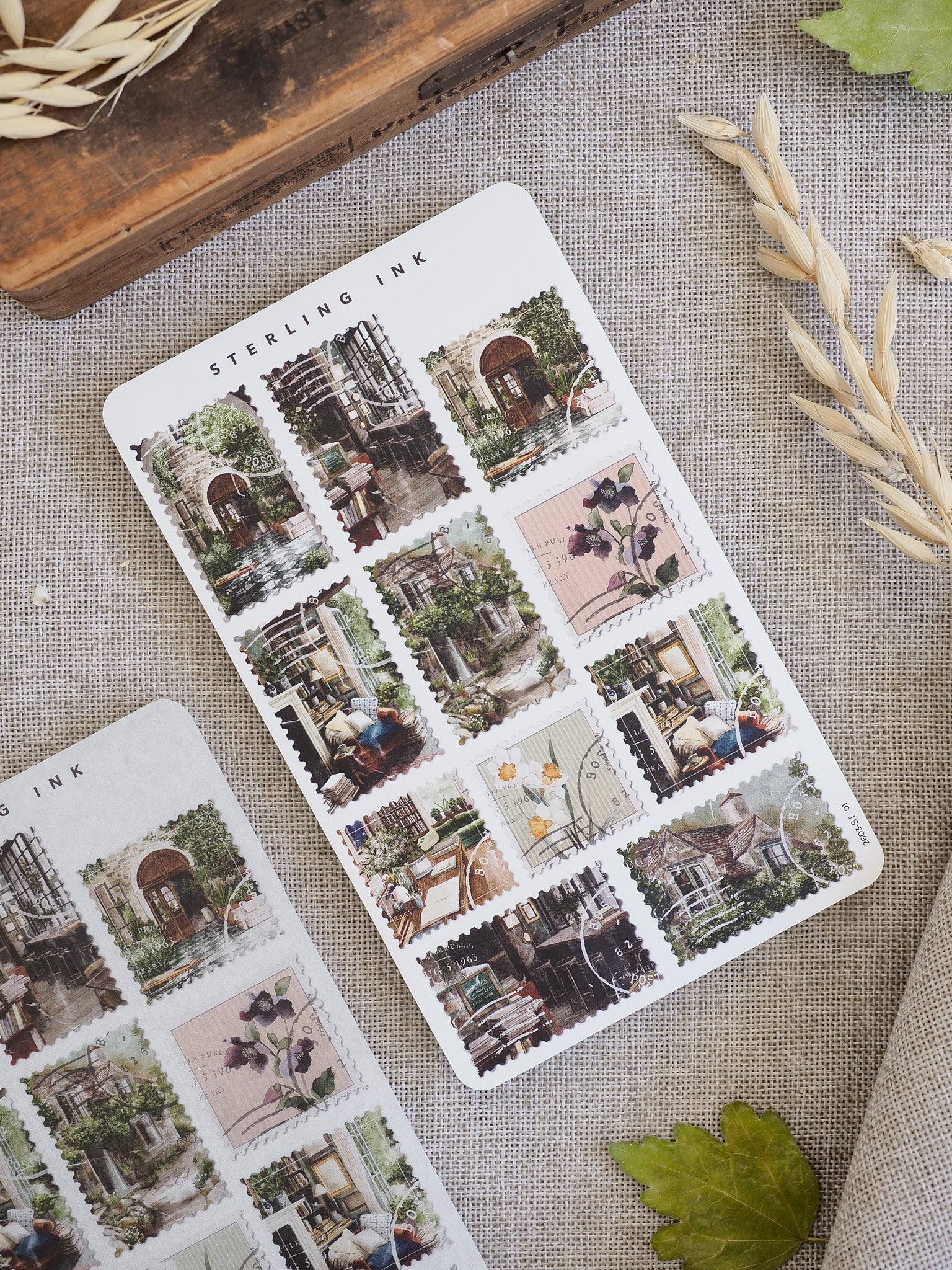 Decorative sheet of 'Stamps Stickers - March 2026' featuring vintage illustrations of charming old-world storefronts, bustling urban scenes, and delicate botanical accents.