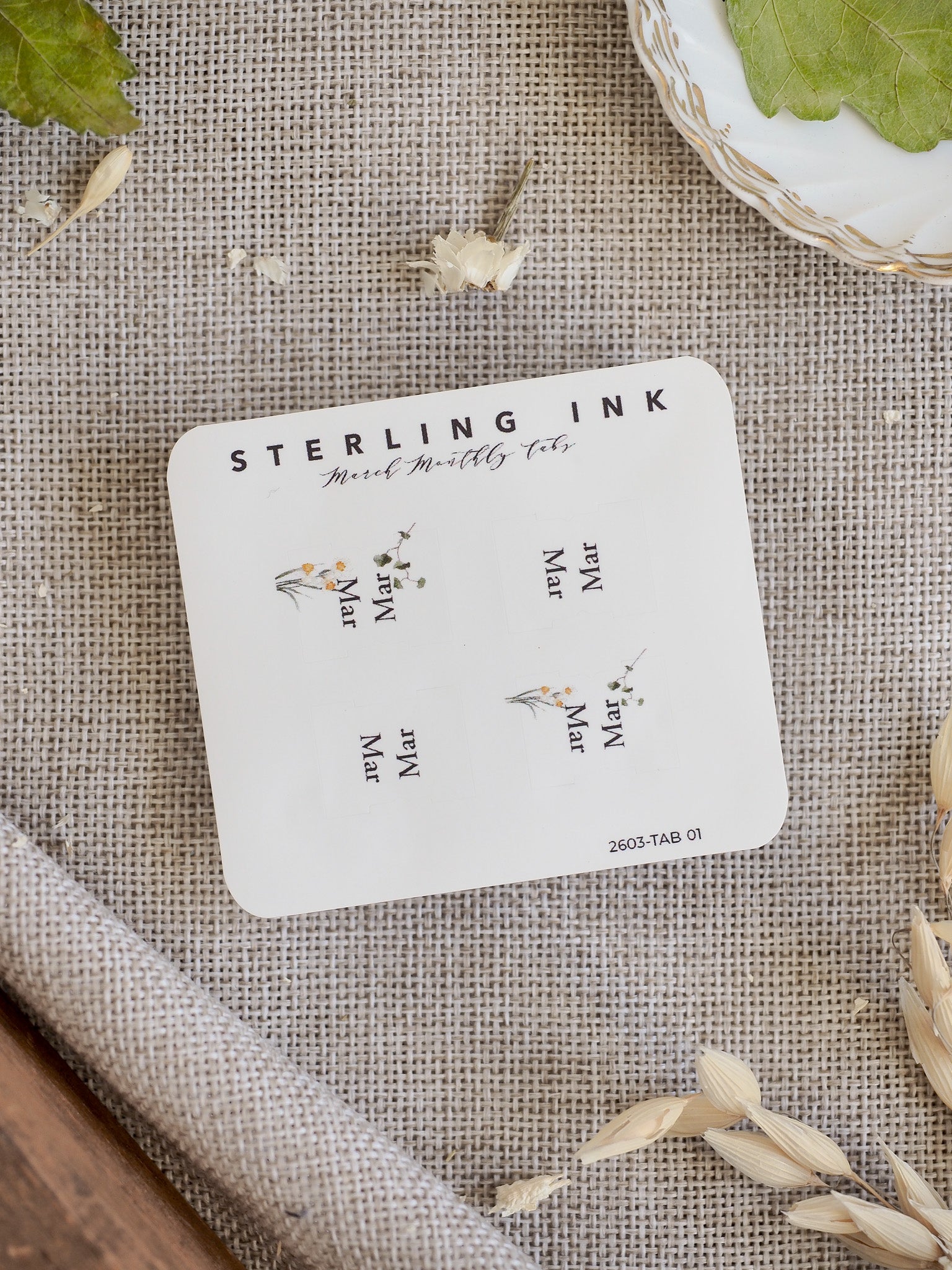 Elegant, white printable planner tabs for March, decorated with delicate yellow and green botanical illustrations perfect for adding a seasonal touch to journaling and scrapbooking.