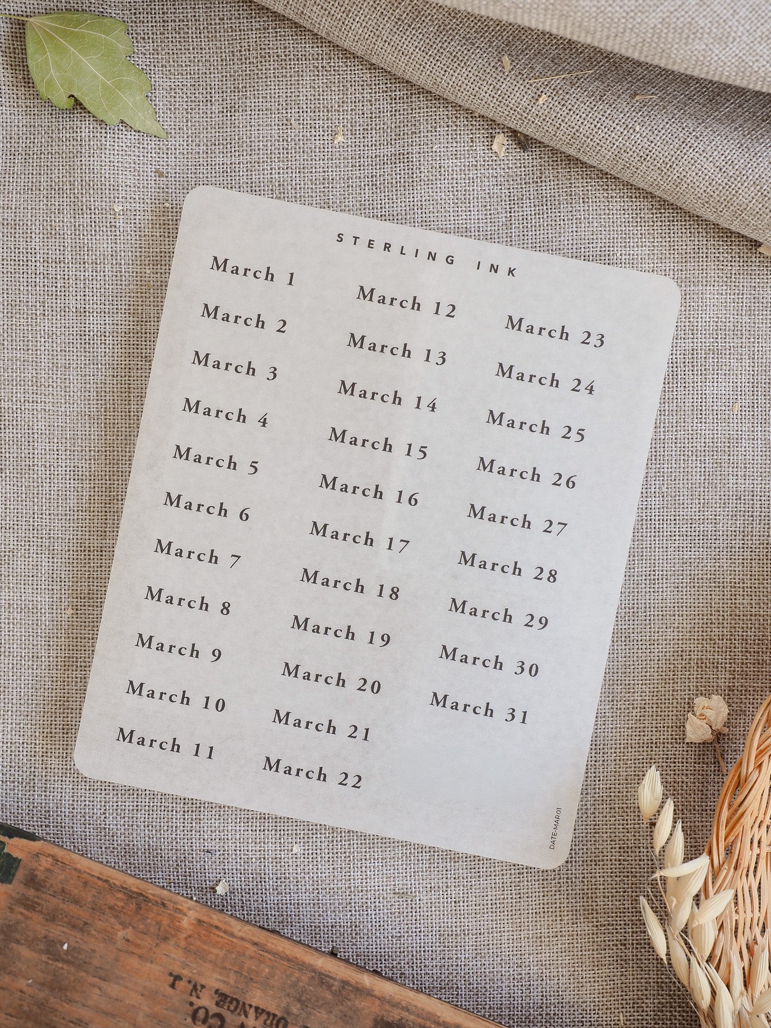 Minimalist white sheet of 'March 2026' date stickers, featuring cleanly printed dates for use in planners and scrapbooking.