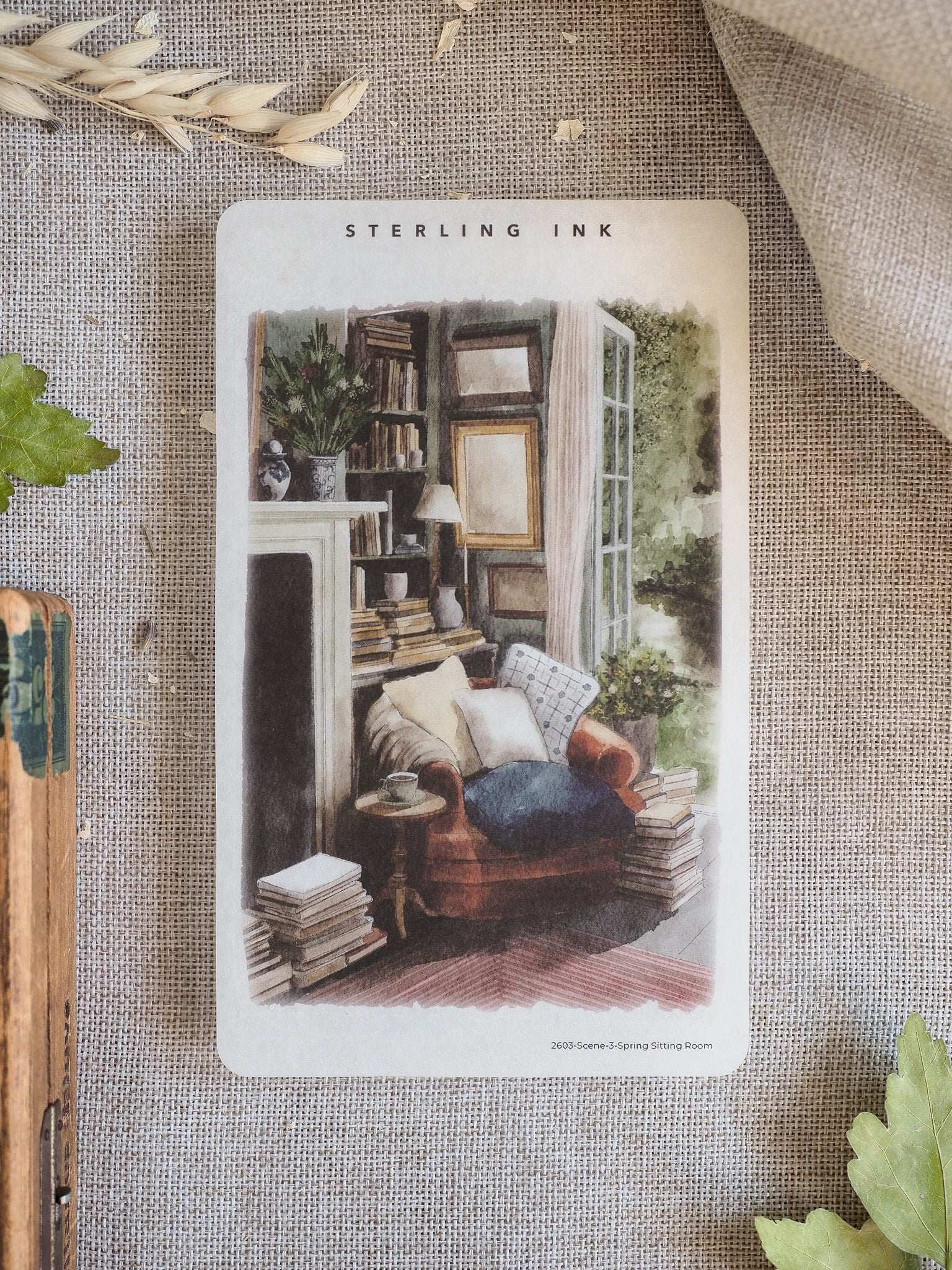 Cozy illustrated spring sitting room sticker depicting a richly furnished interior with a sofa, bookshelves, and fireplace.
