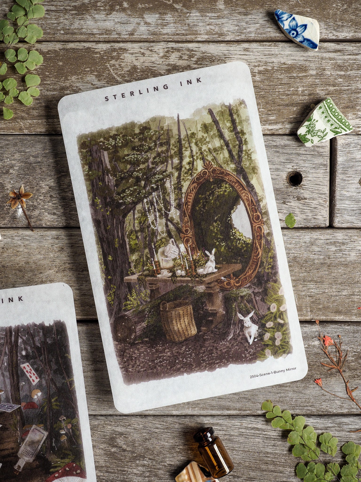 Detailed vintage illustration sticker of a hidden forest scene featuring a rustic table, a decorative mirror, and small white bunnies.
