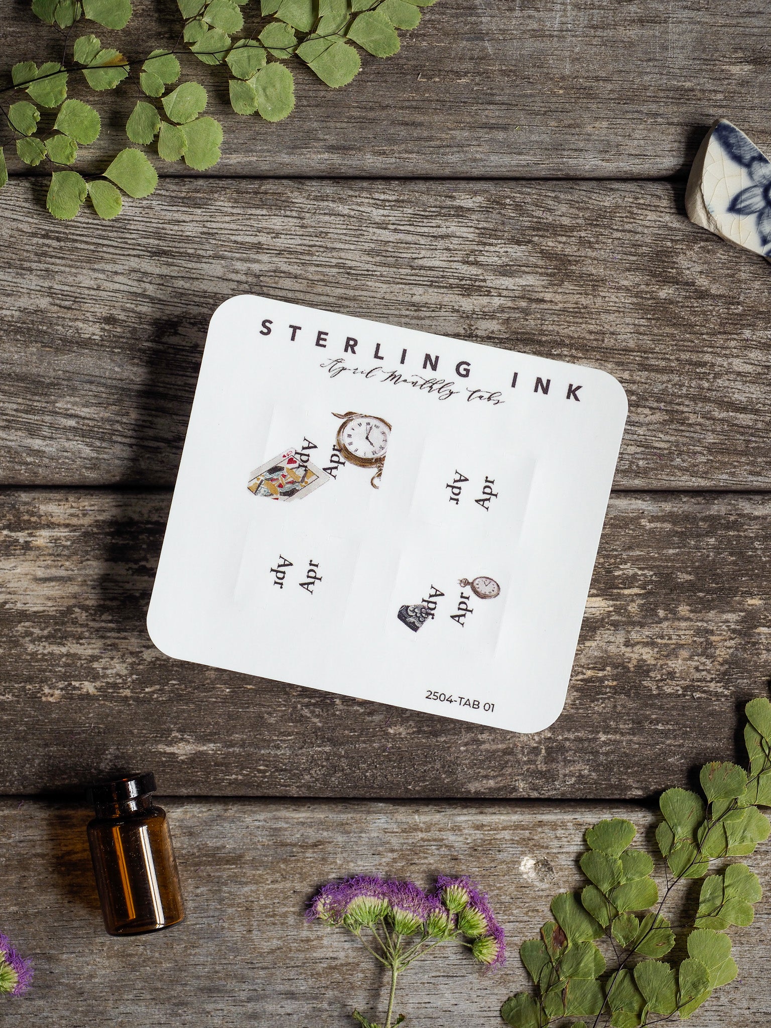 A set of six white monthly planner tabs featuring coordinating vintage clock and timepiece illustrations, perfect for tracking April 2025.
