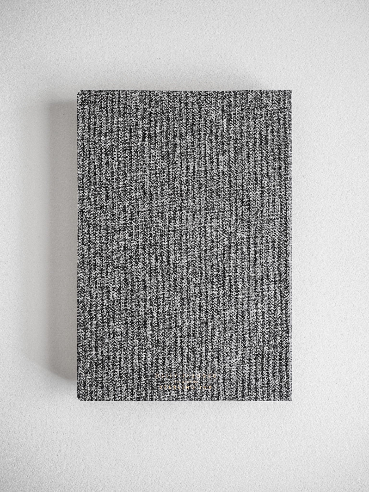 Textured, dark charcoal gray academic daily planner with a solid, uniform cover, suitable for year-long academic planning.