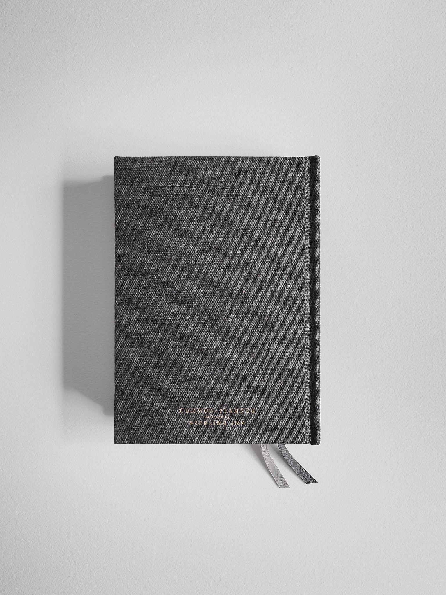 Textured, dark gray academic planner featuring elegant foiled lettering that reads "COMMON PLANNER" and "STERLING INK."
