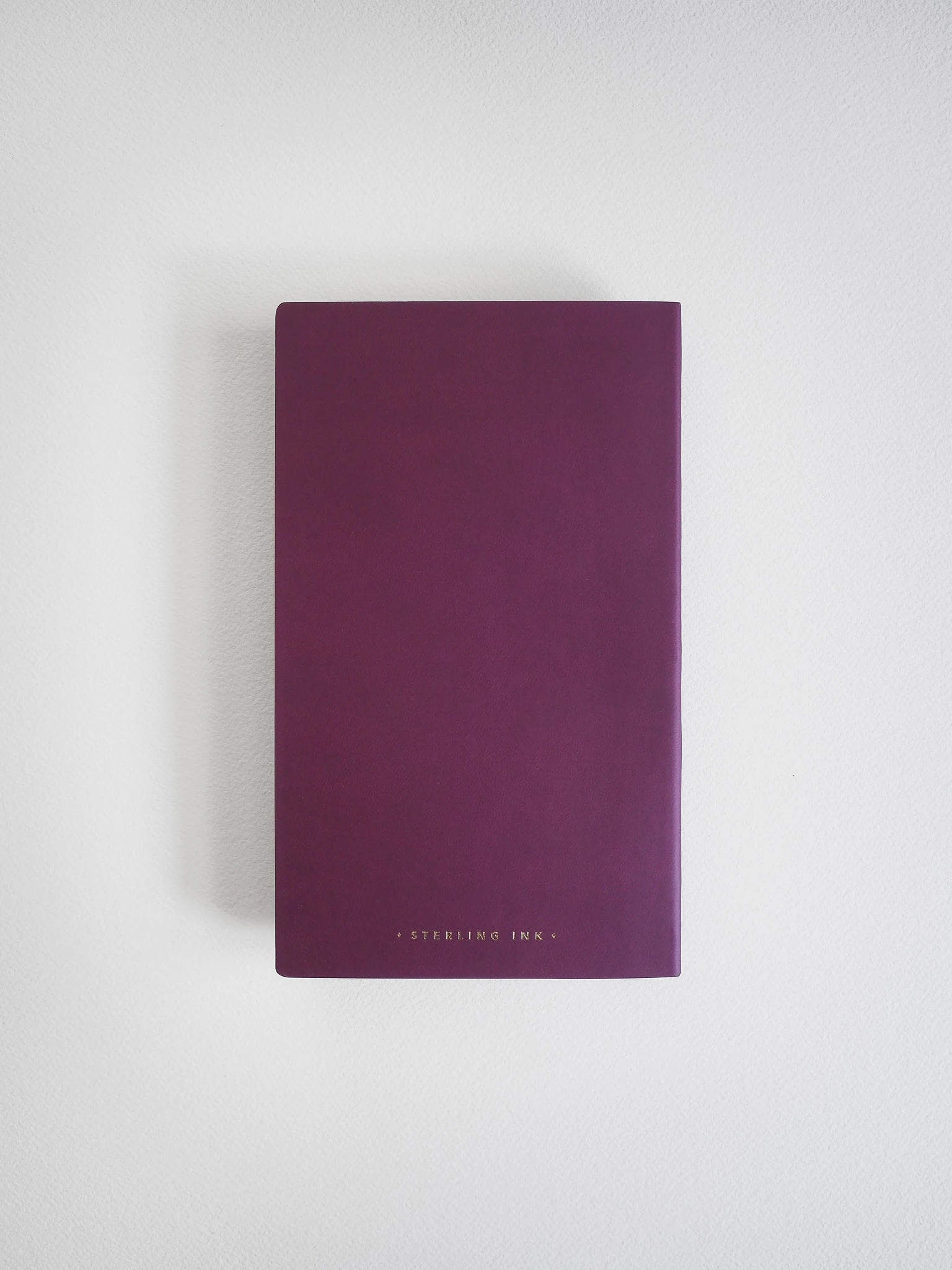 A dark purple notebook or journal with 'STERLING INK.' printed in small gold letters at the bottom, centered on a light gray background.
#Color_Mulberry