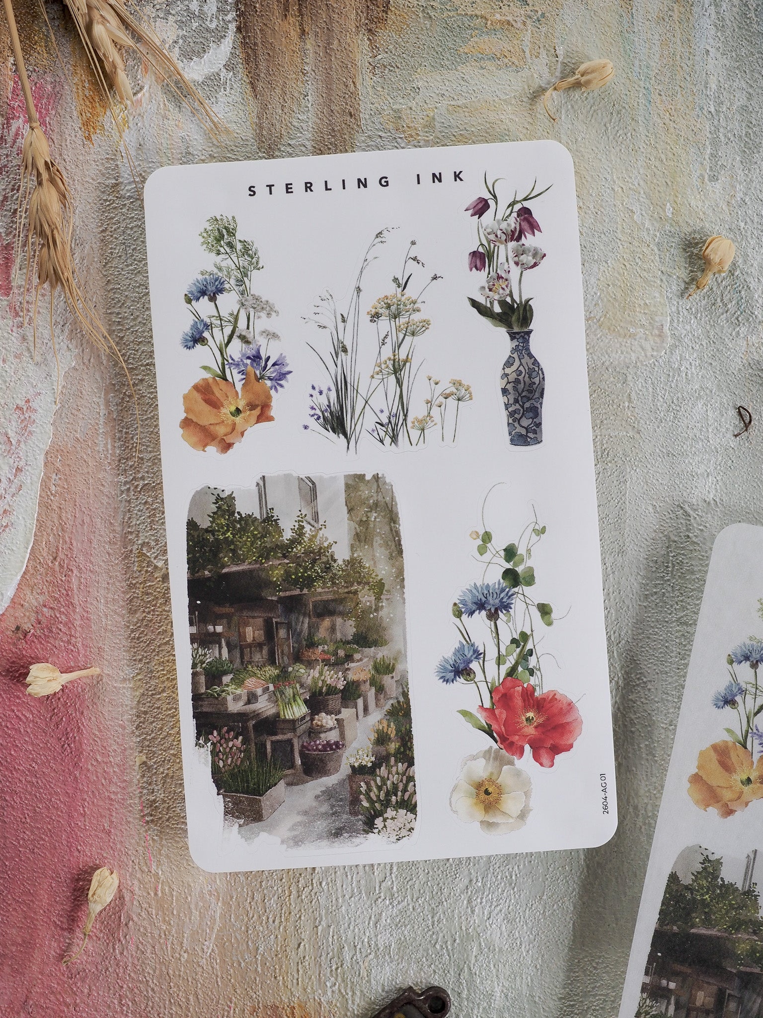 Decorative sticker sheet featuring a spring garden theme with watercolor botanical illustrations, colorful floral bouquets, and a charming market scene.