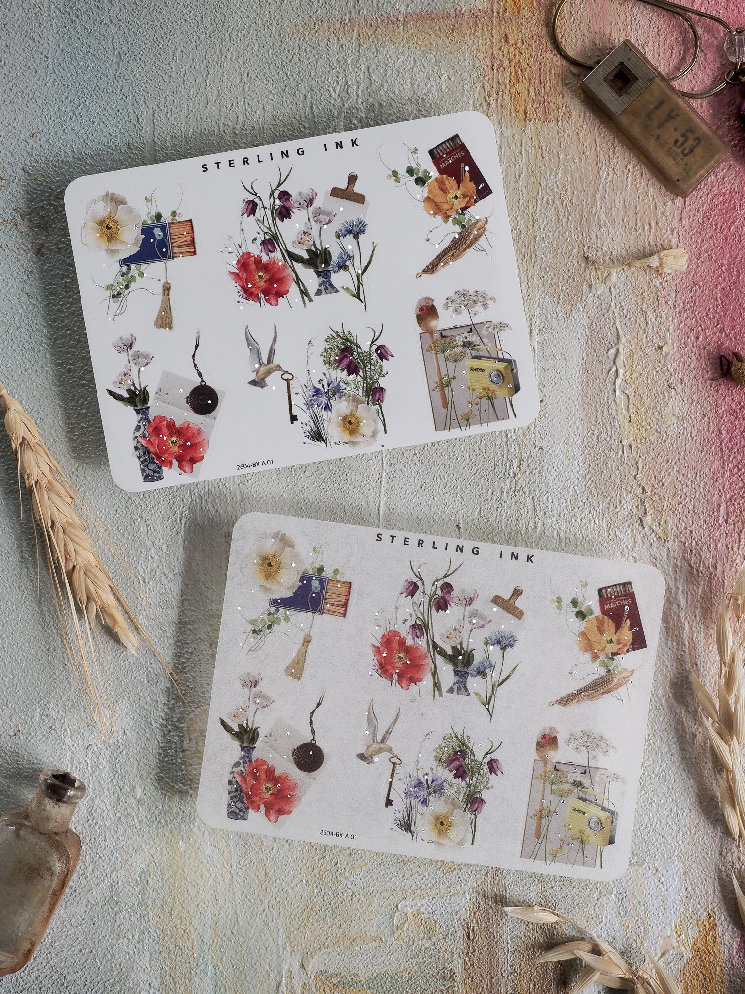 A collection of white sticker sheets featuring pastel botanical designs, adorned with watercolor flowers, delicate foliage, and decorative corner embellishments.